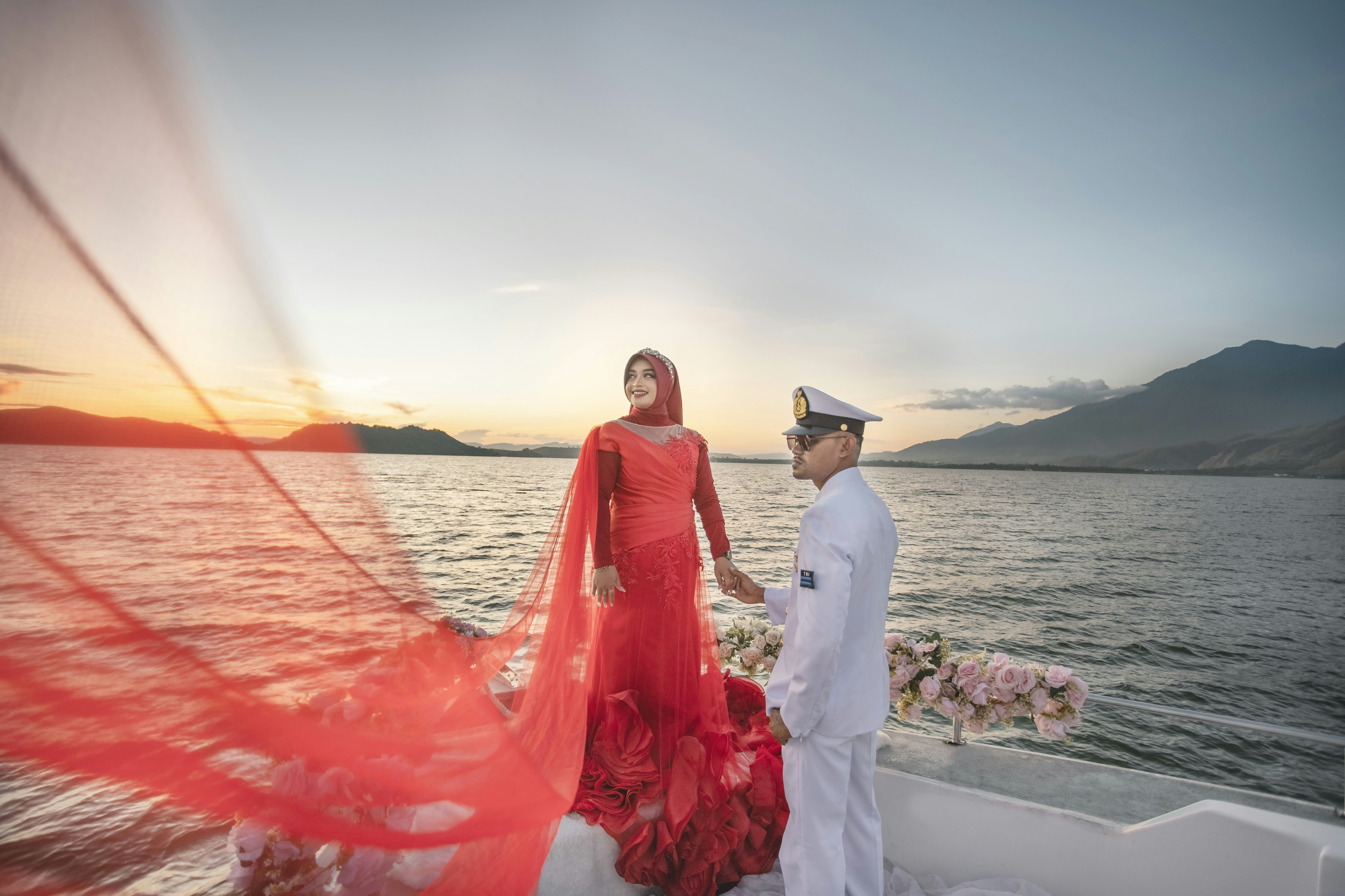 A man and a woman on a boat at sunset