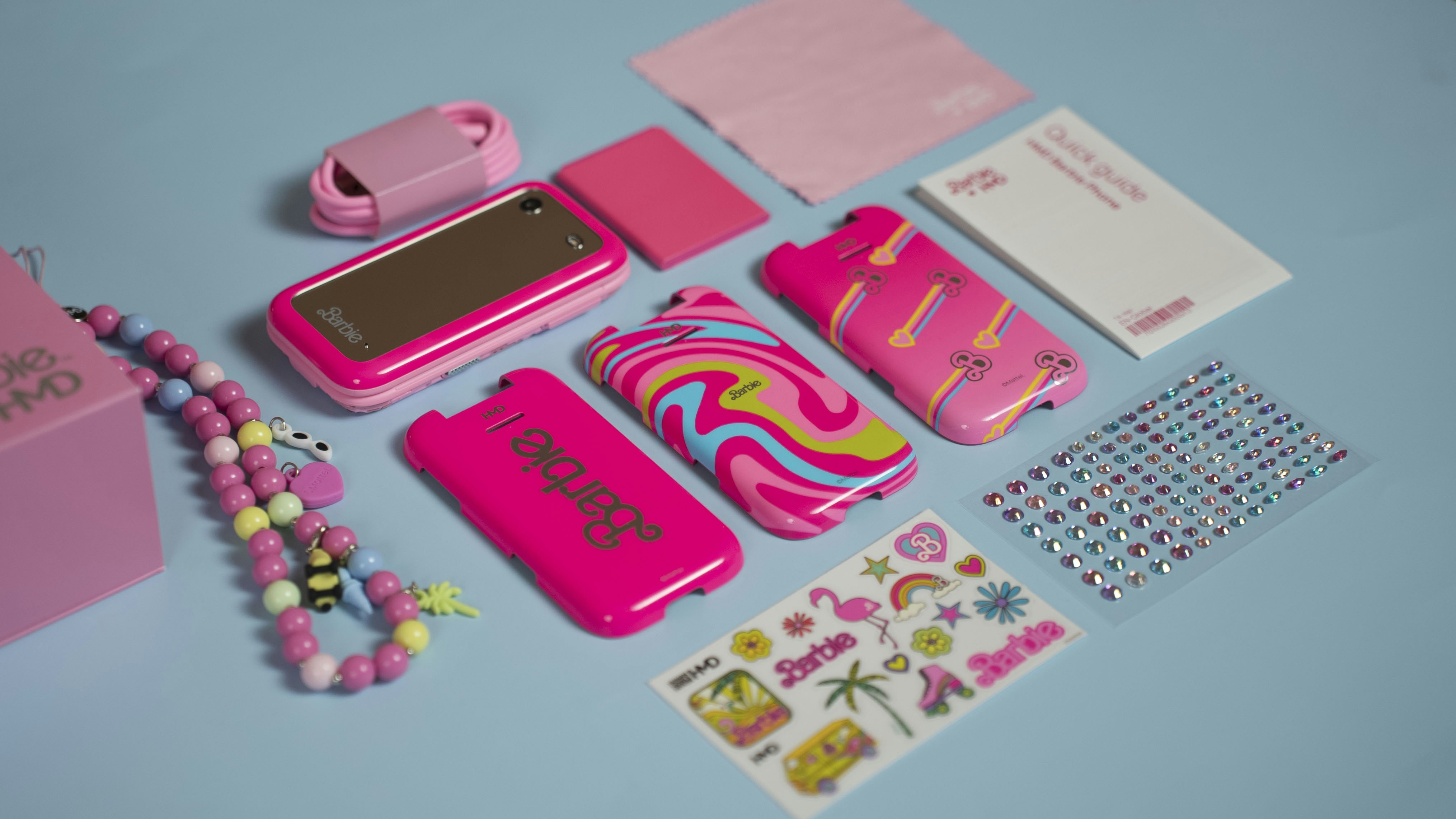 A blue table topped with lots of pink items