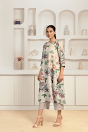 A woman standing in front of a display of vases