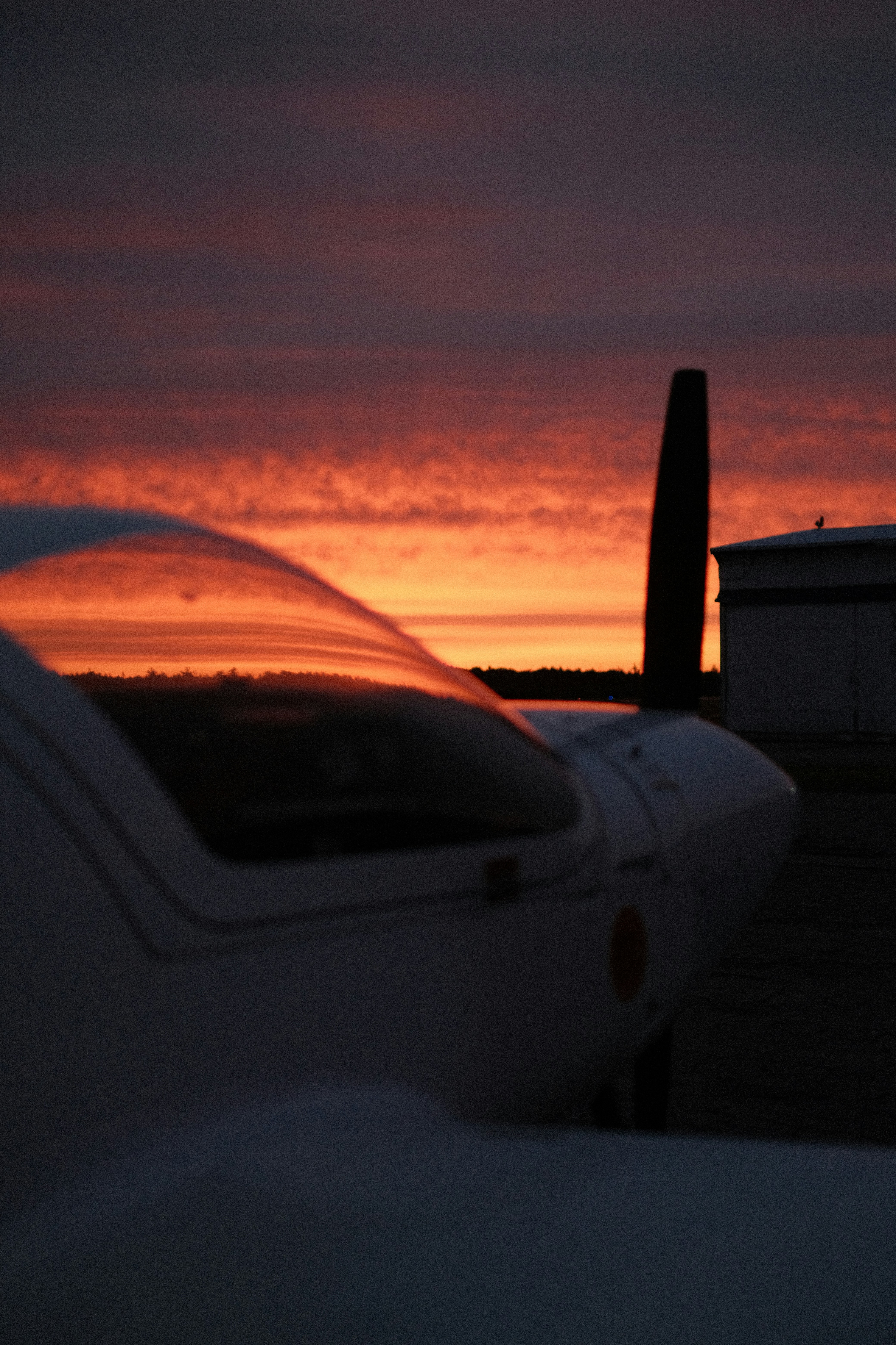 A plane sitting on top of an airport tarmac