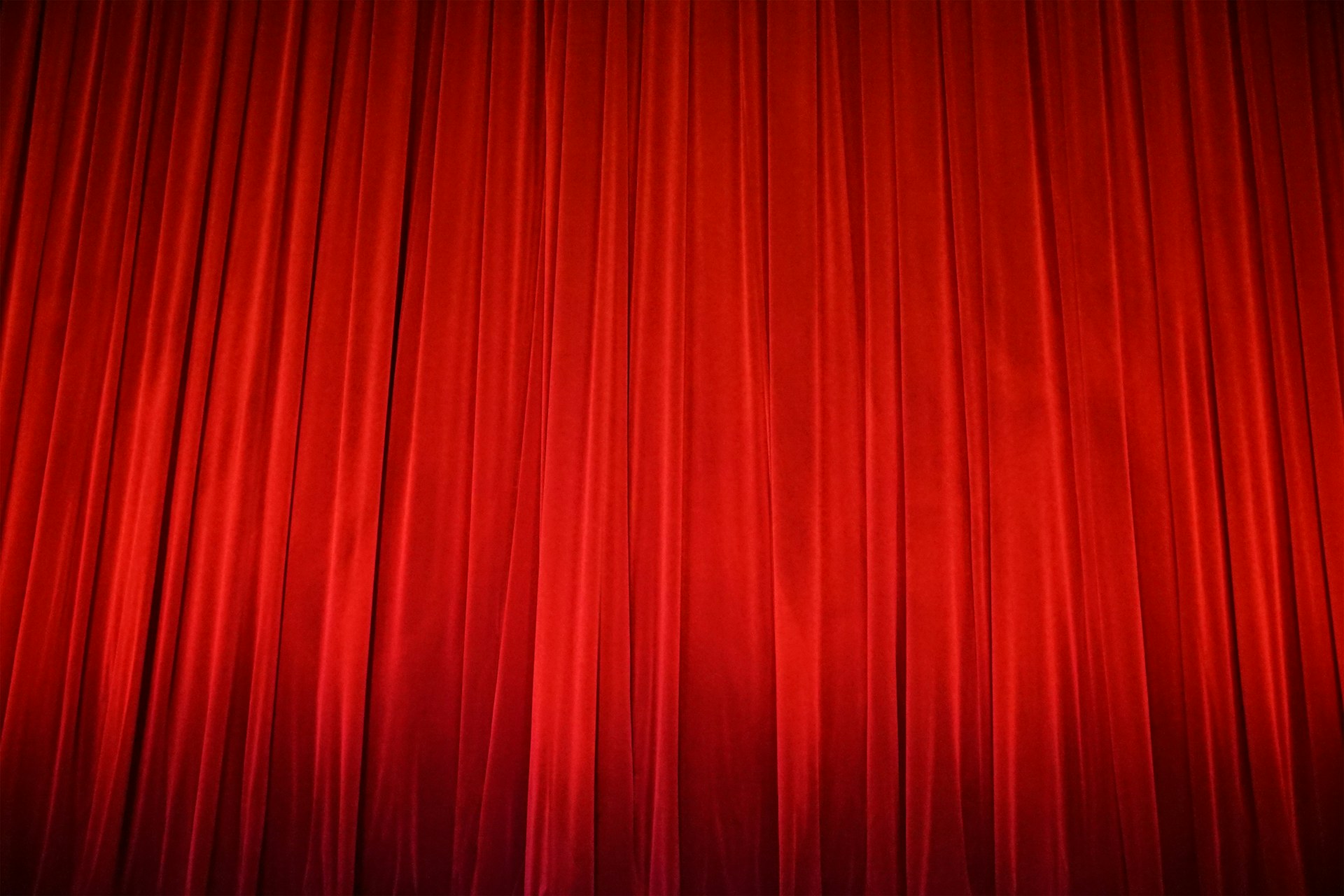 A red curtain with a black background