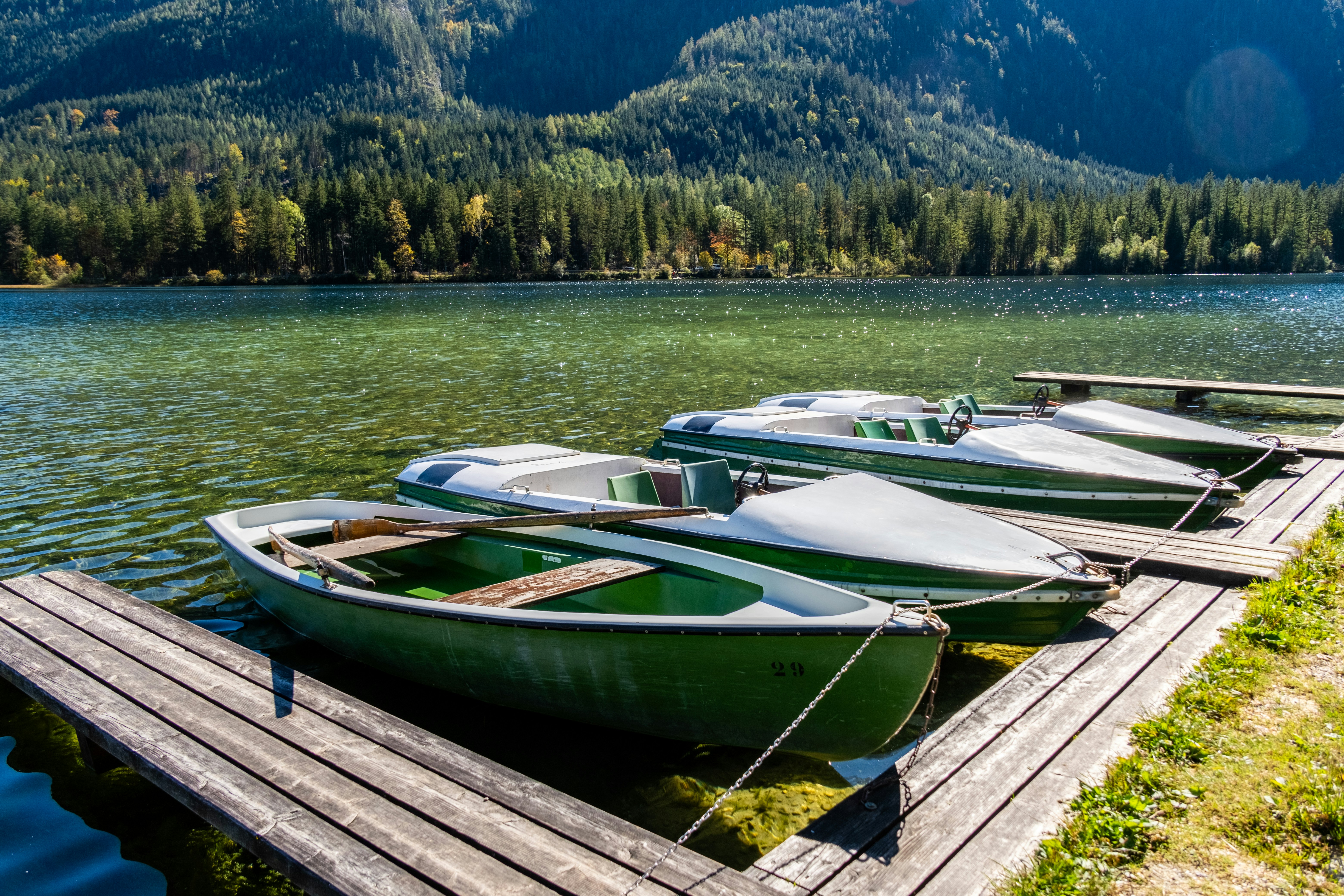 A row of boats sitting on top of a wooden dock