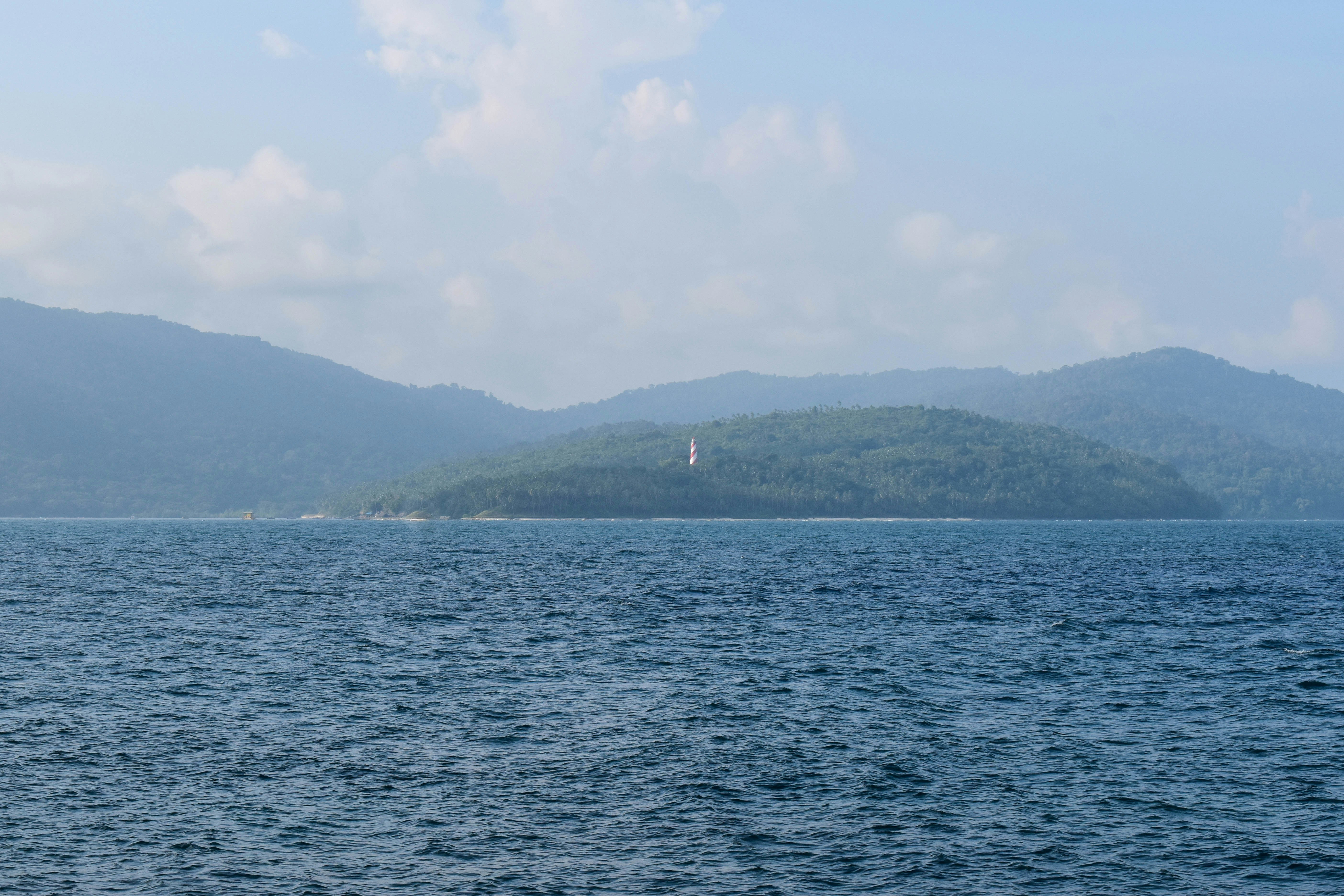 A body of water with mountains in the background