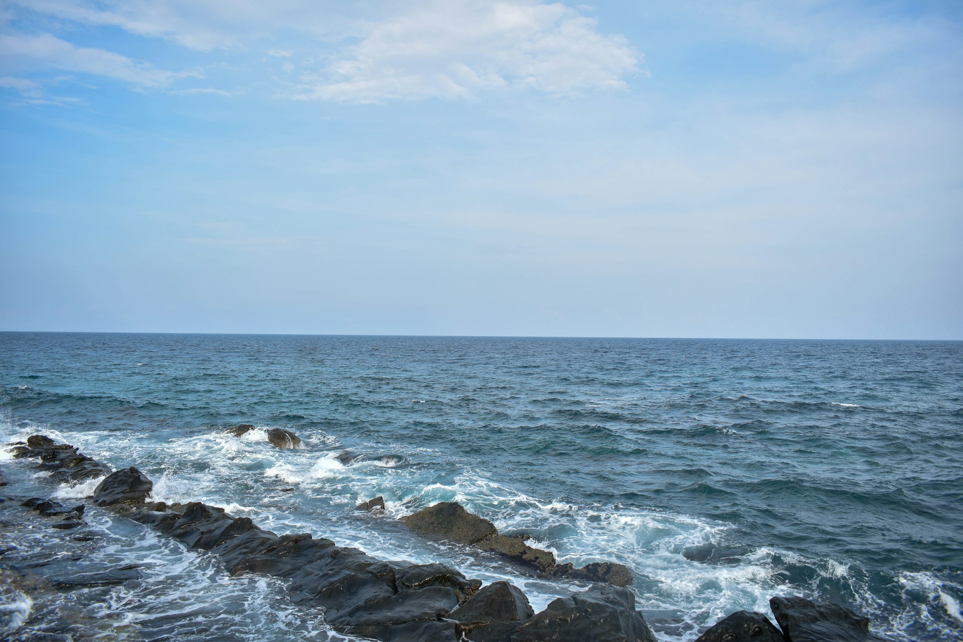 A view of the ocean from a rocky shore