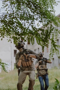 A group of men with guns walking through a field