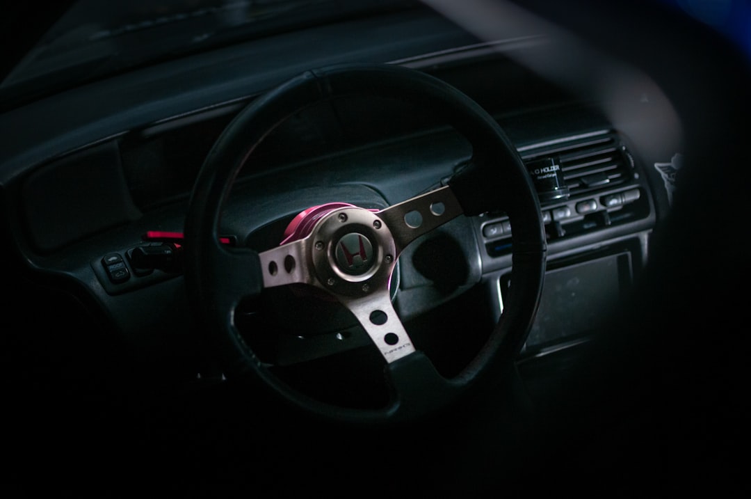 A steering wheel and dashboard of a car,