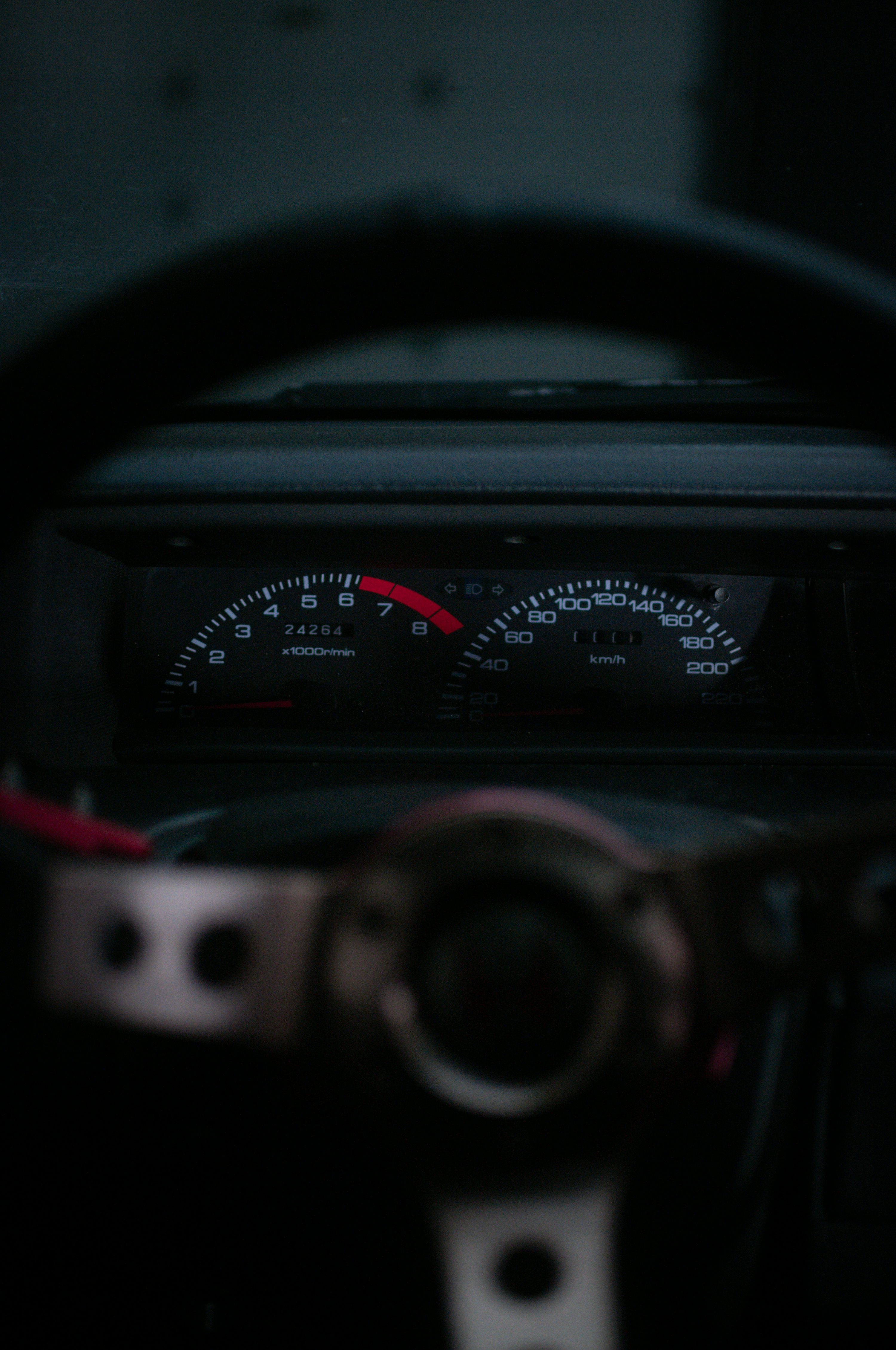 A car dashboard with a speedometer and gauges
