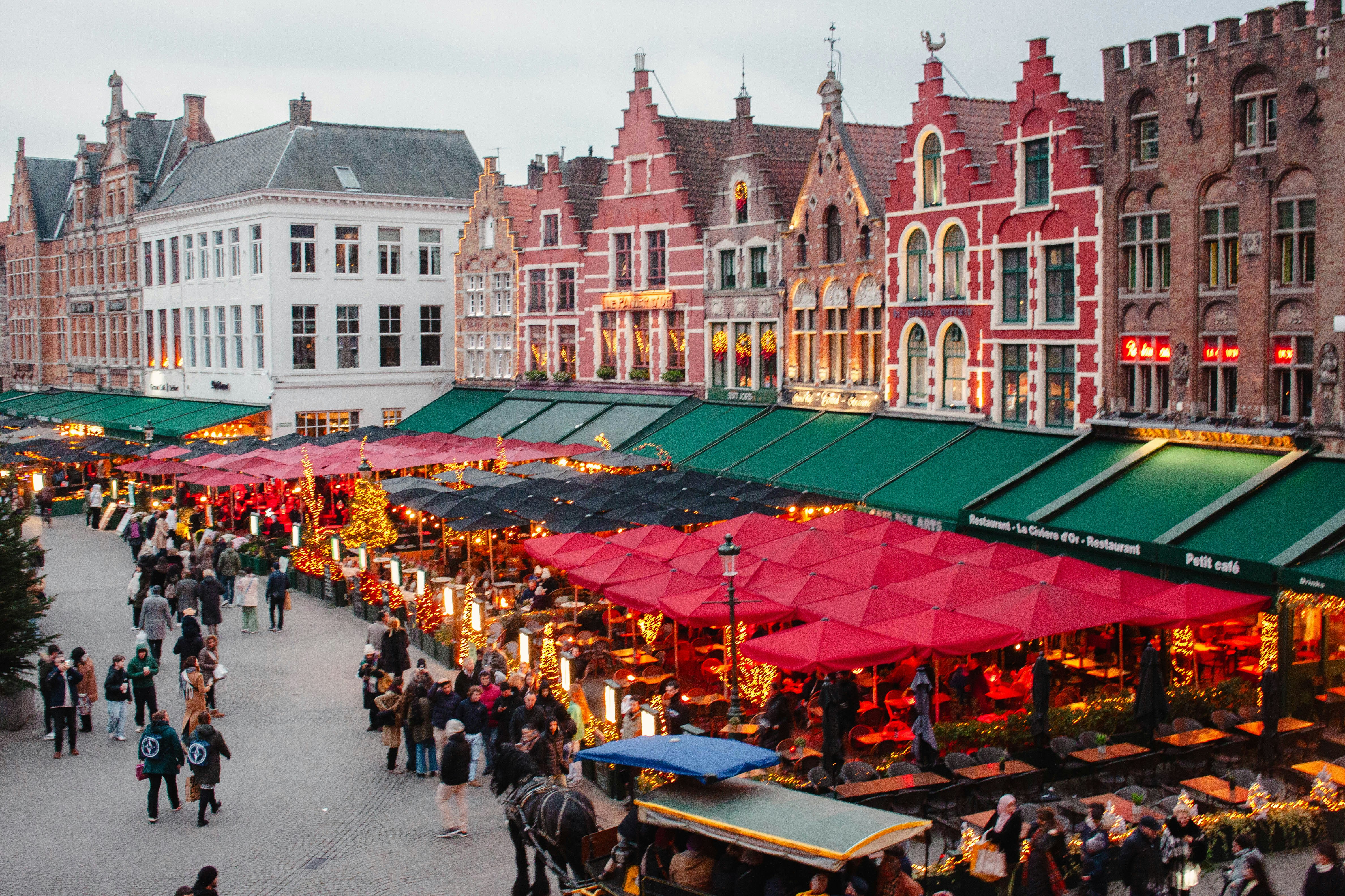A group of people walking around a market
