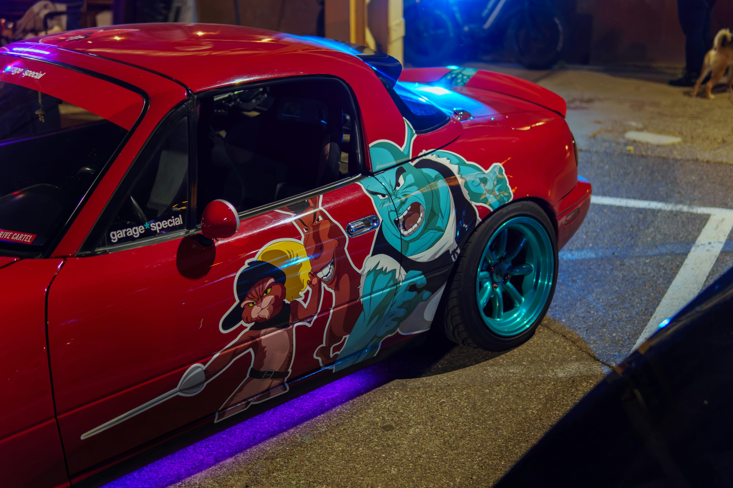 A red sports car parked on the side of the road