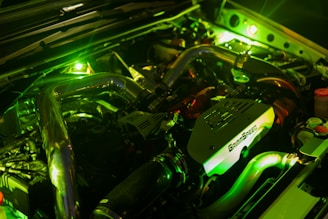 A close up of a car engine with its lights on