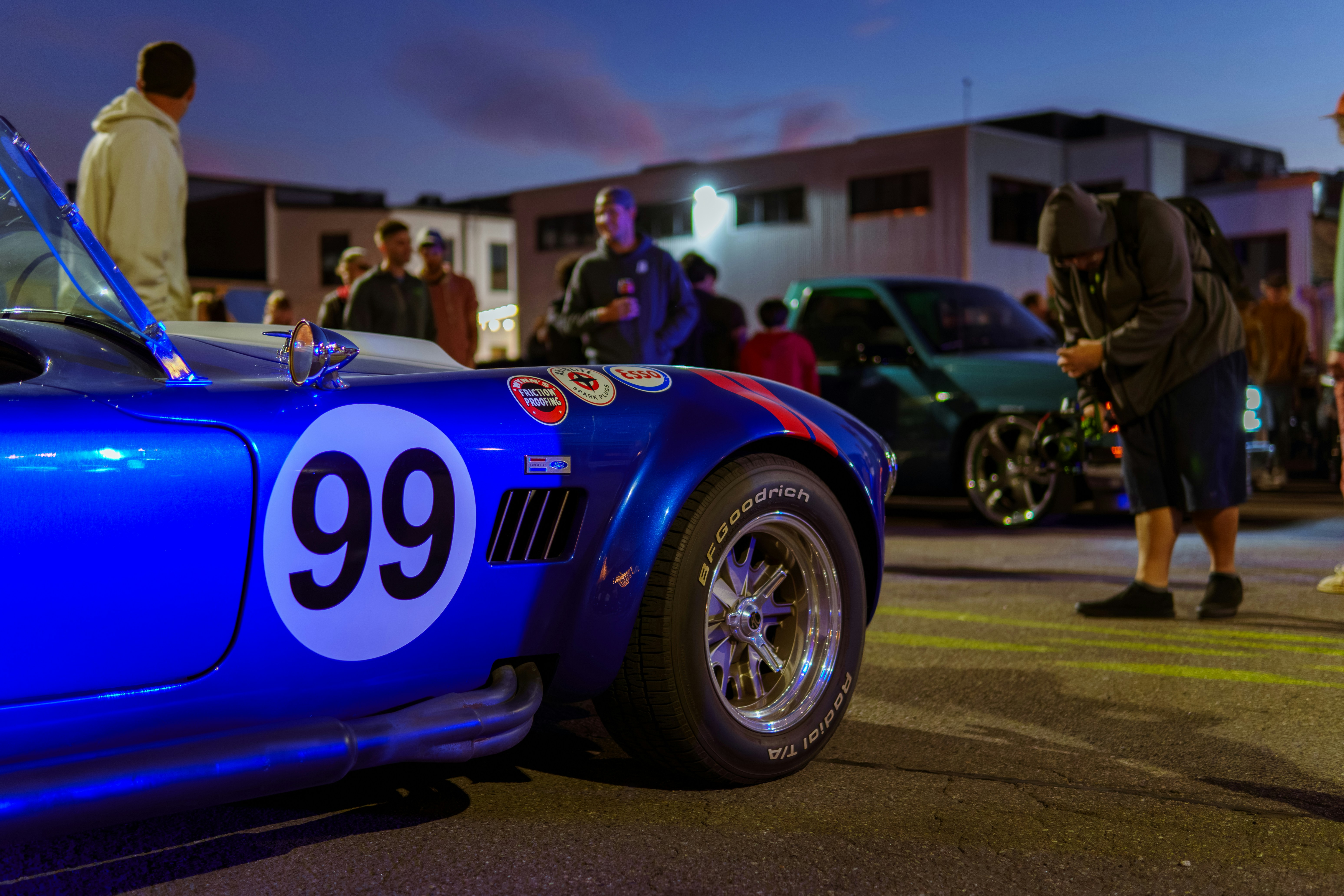 A blue sports car with a number 99 on it