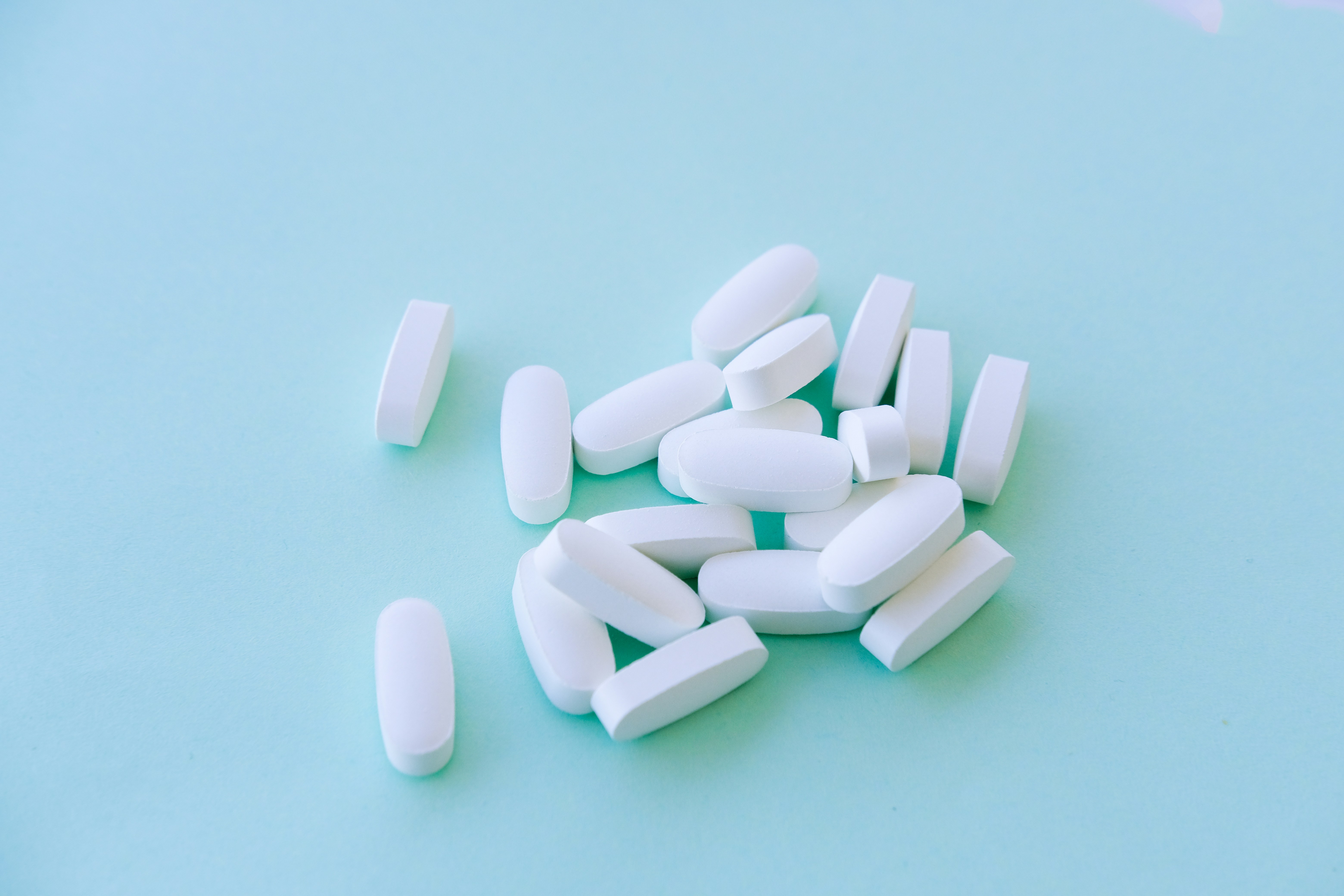 A pile of pills sitting on top of a blue table