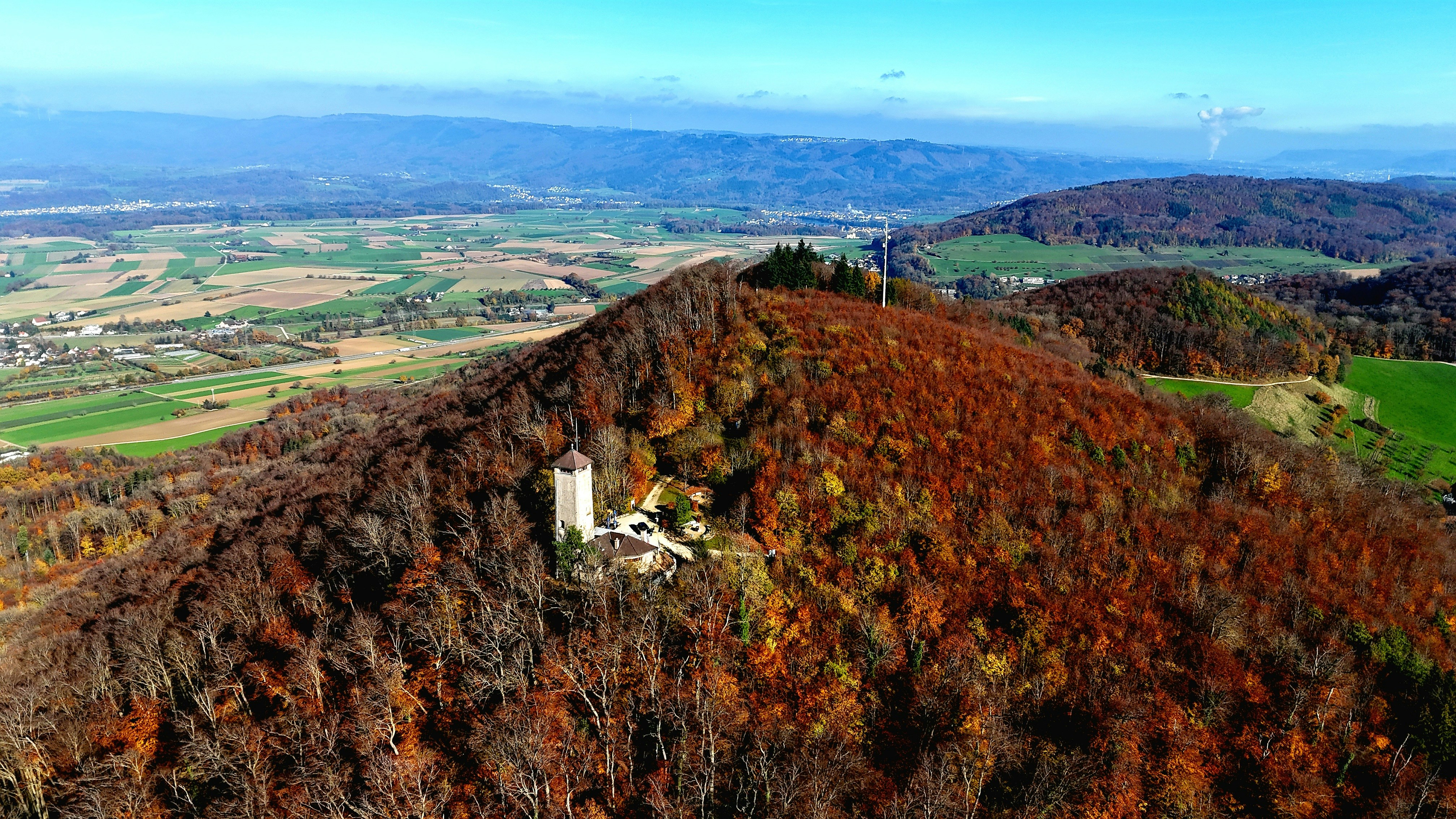 A view of a mountain with a small tower on top of it