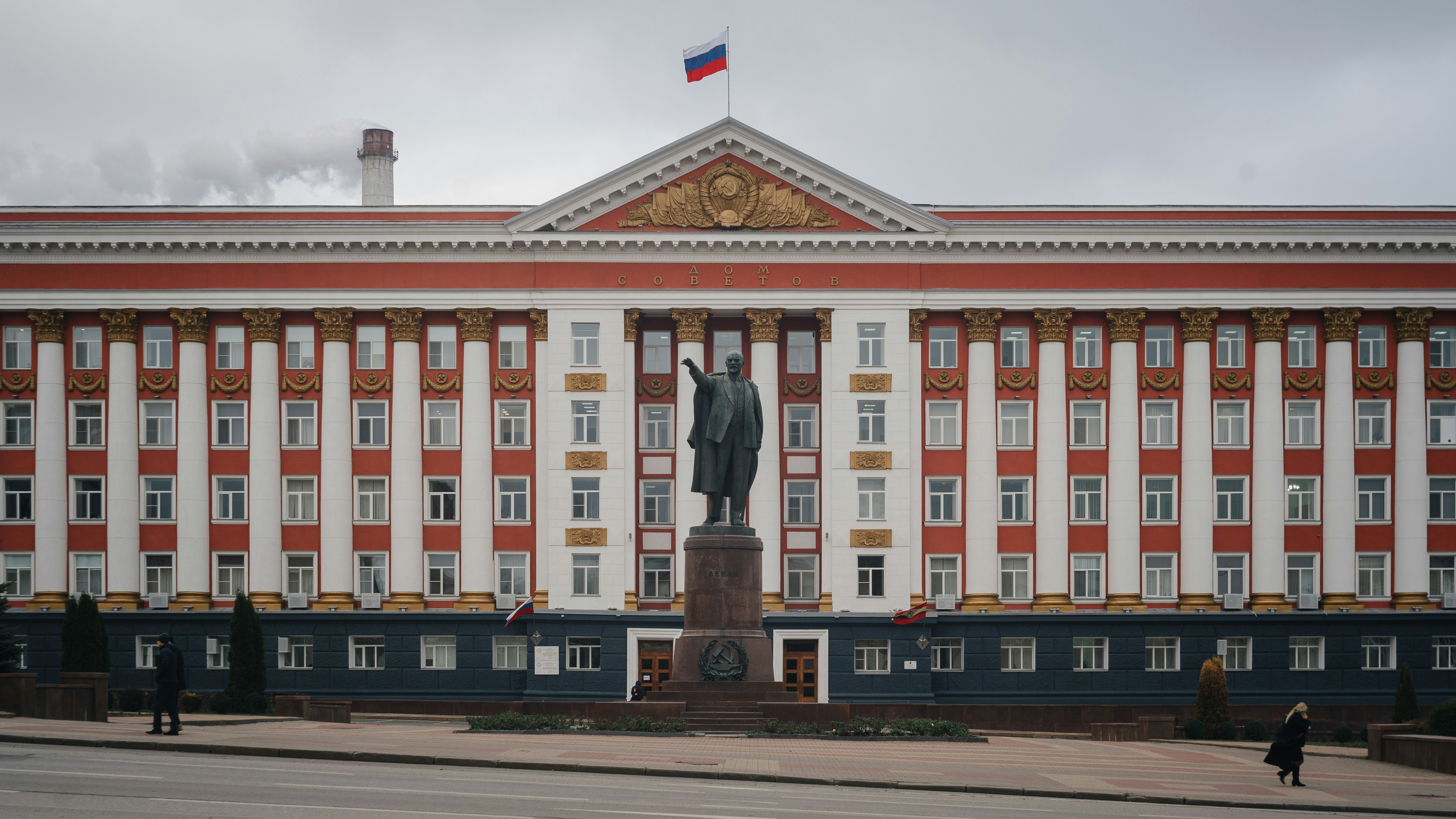A large building with a statue in front of it