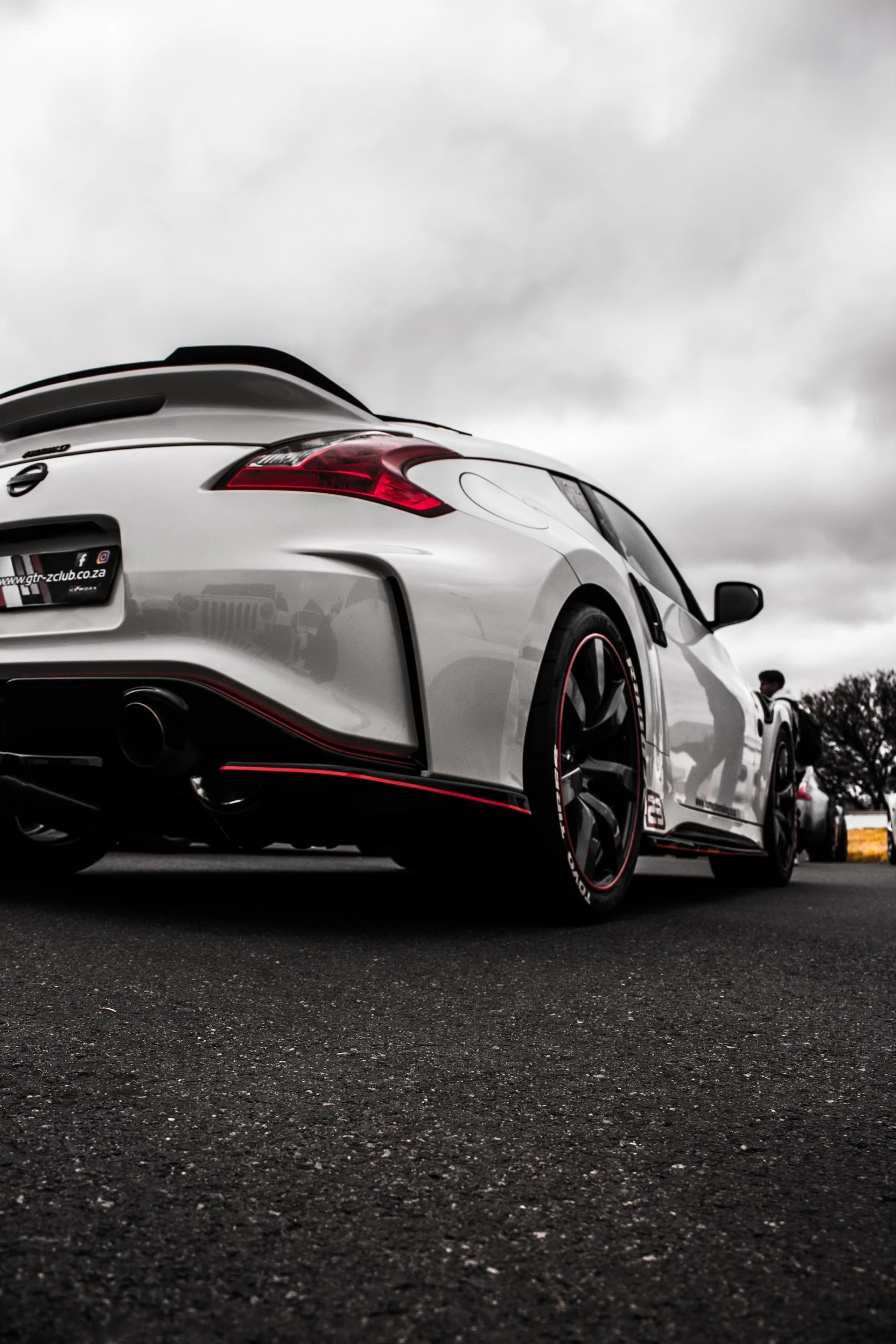 A white sports car parked on the side of the road