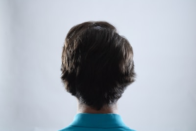 The back of a man's head in a blue shirt