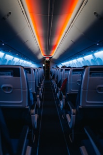 The inside of an airplane with the lights on
