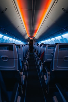 The inside of an airplane with the lights on
