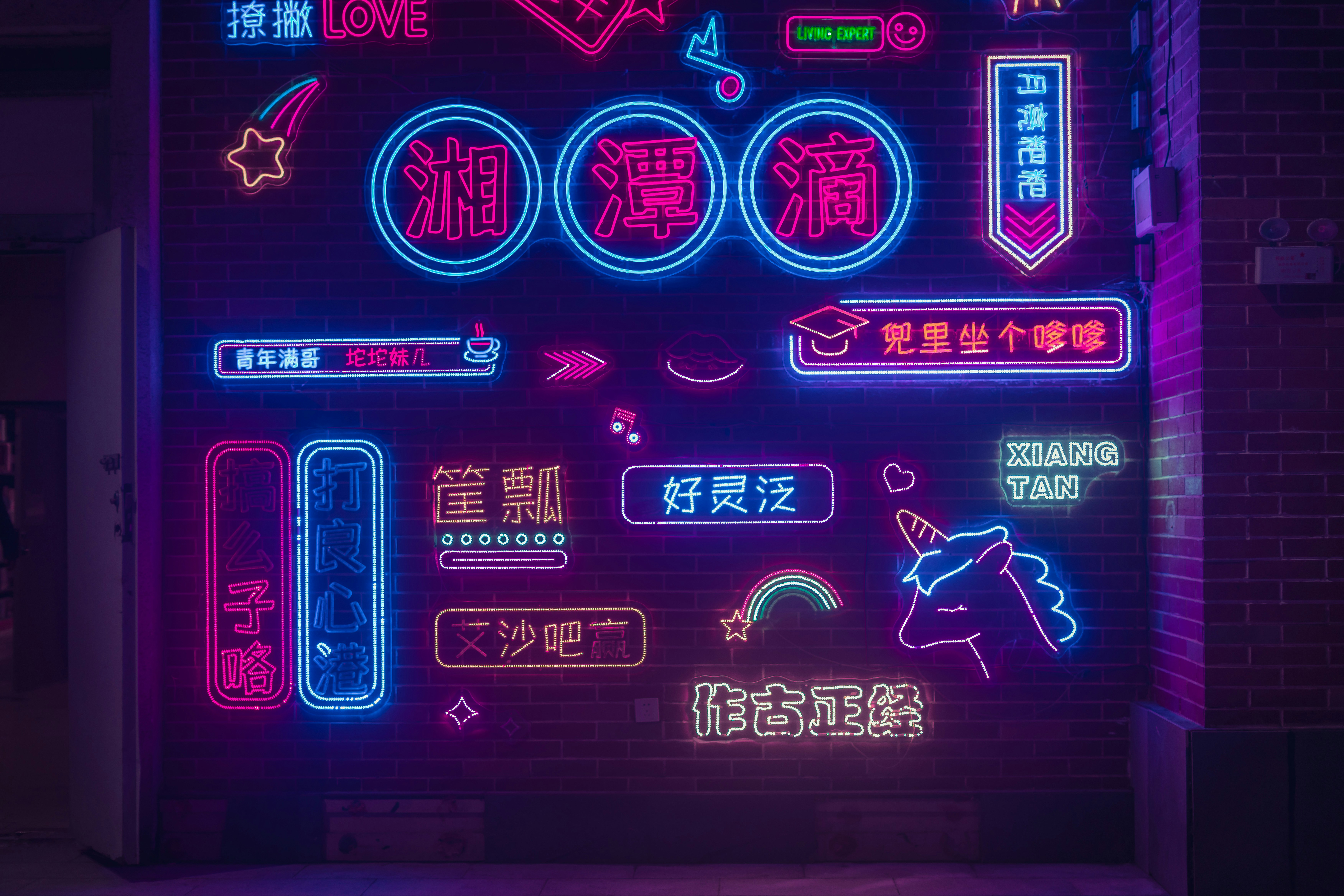 A neon sign that is on the side of a building