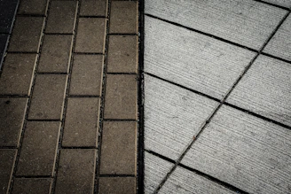 A brick sidewalk next to a brick sidewalk