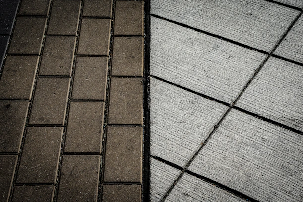 A brick sidewalk next to a brick sidewalk