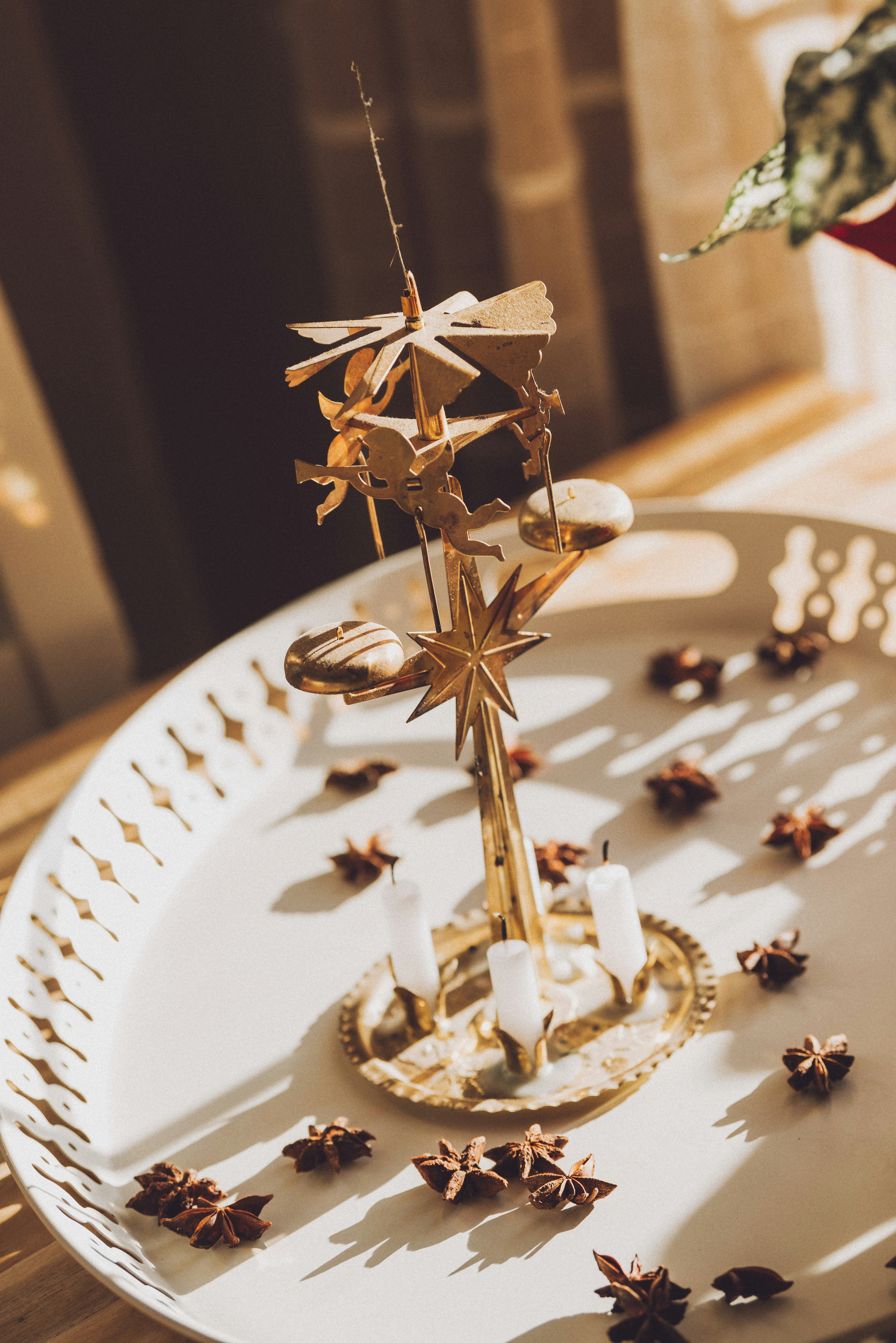 A white tray topped with a gold star candle holder
