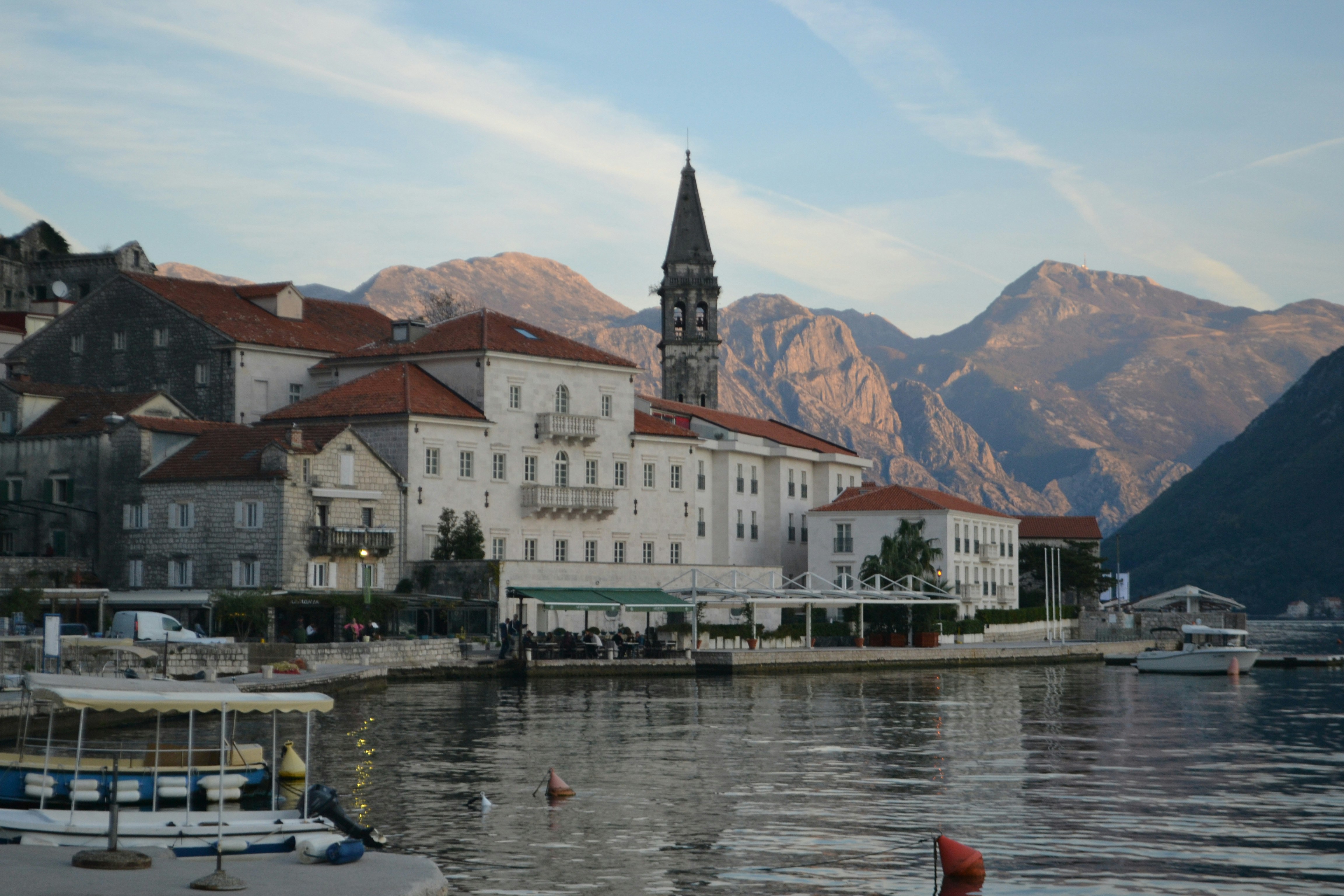 A town on the shore of a lake with mountains in the background