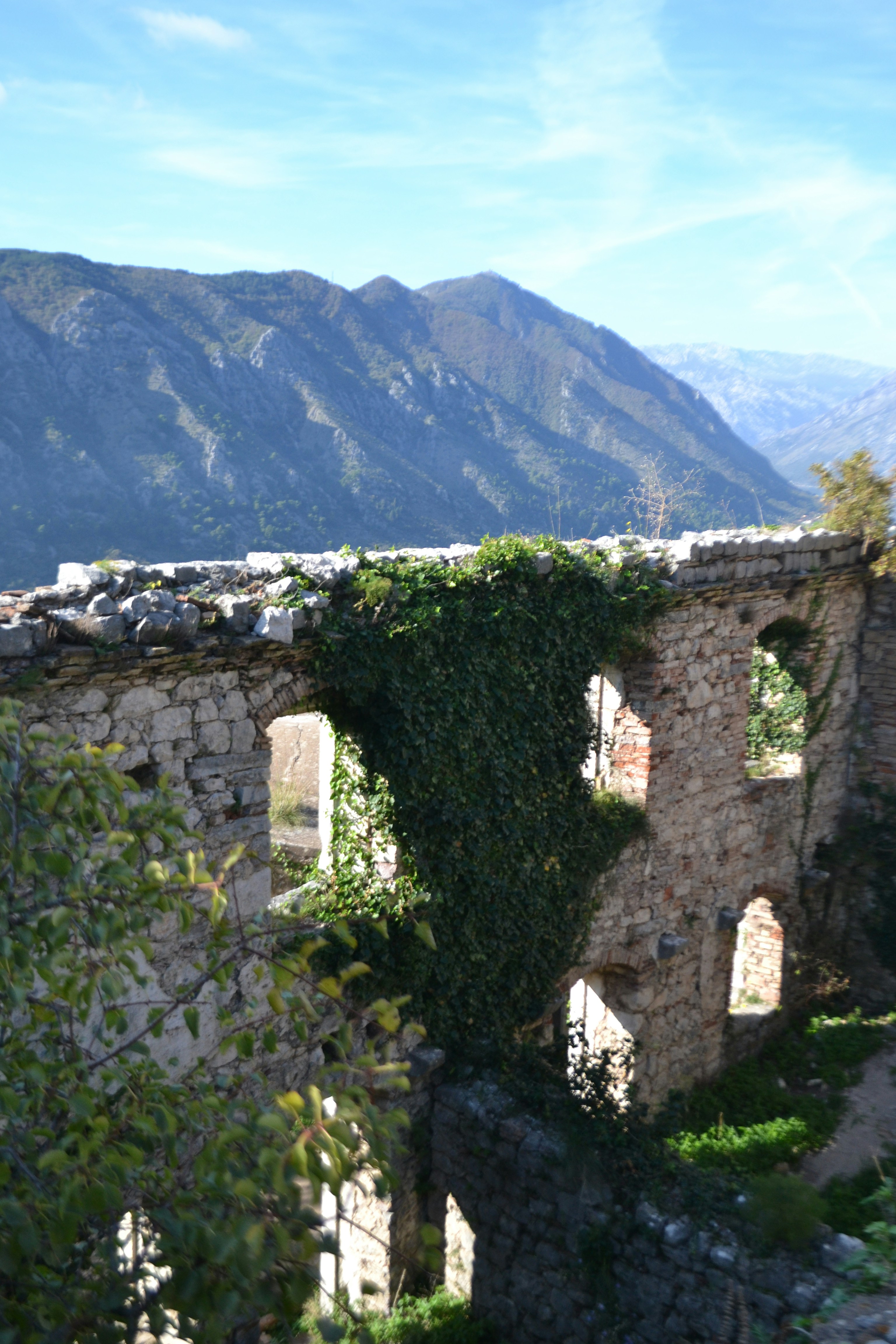A stone building with a mountain in the background