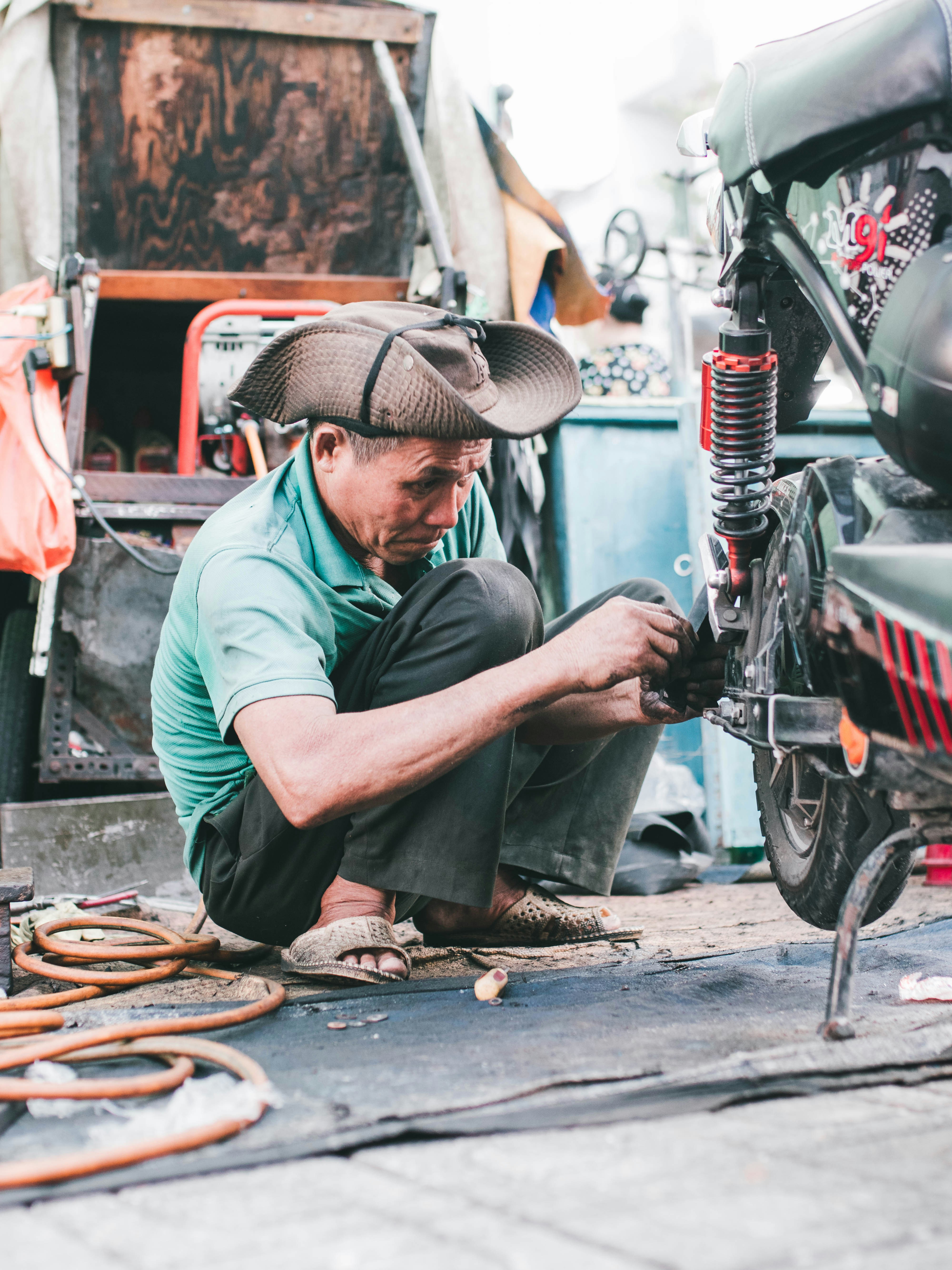 A man working on a motorcycle in a garage