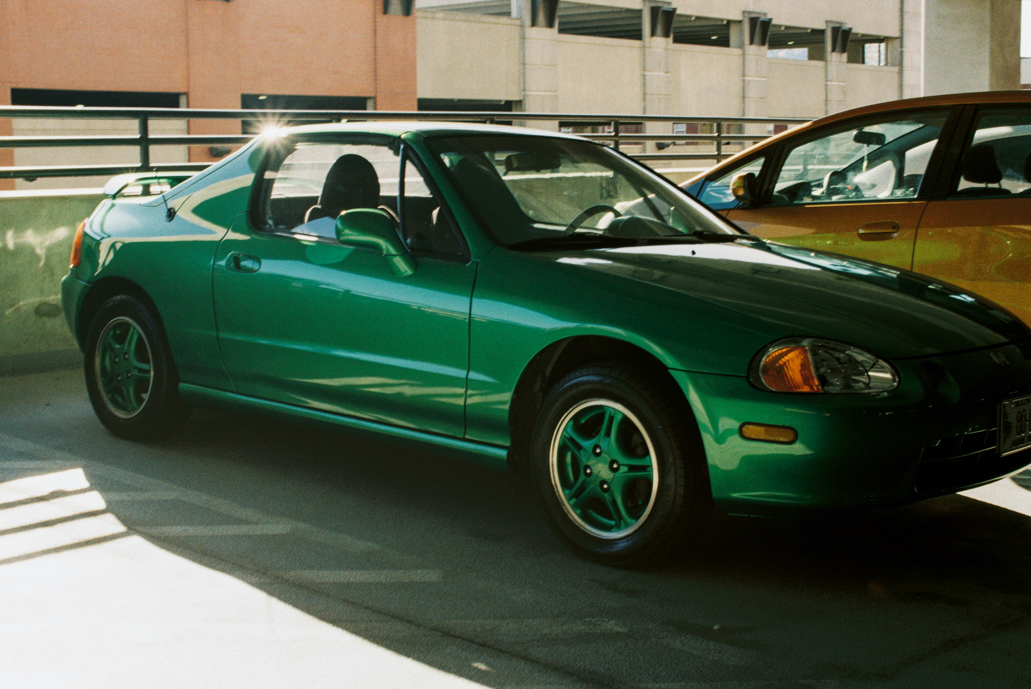 Two cars parked next to each other in a parking lot
