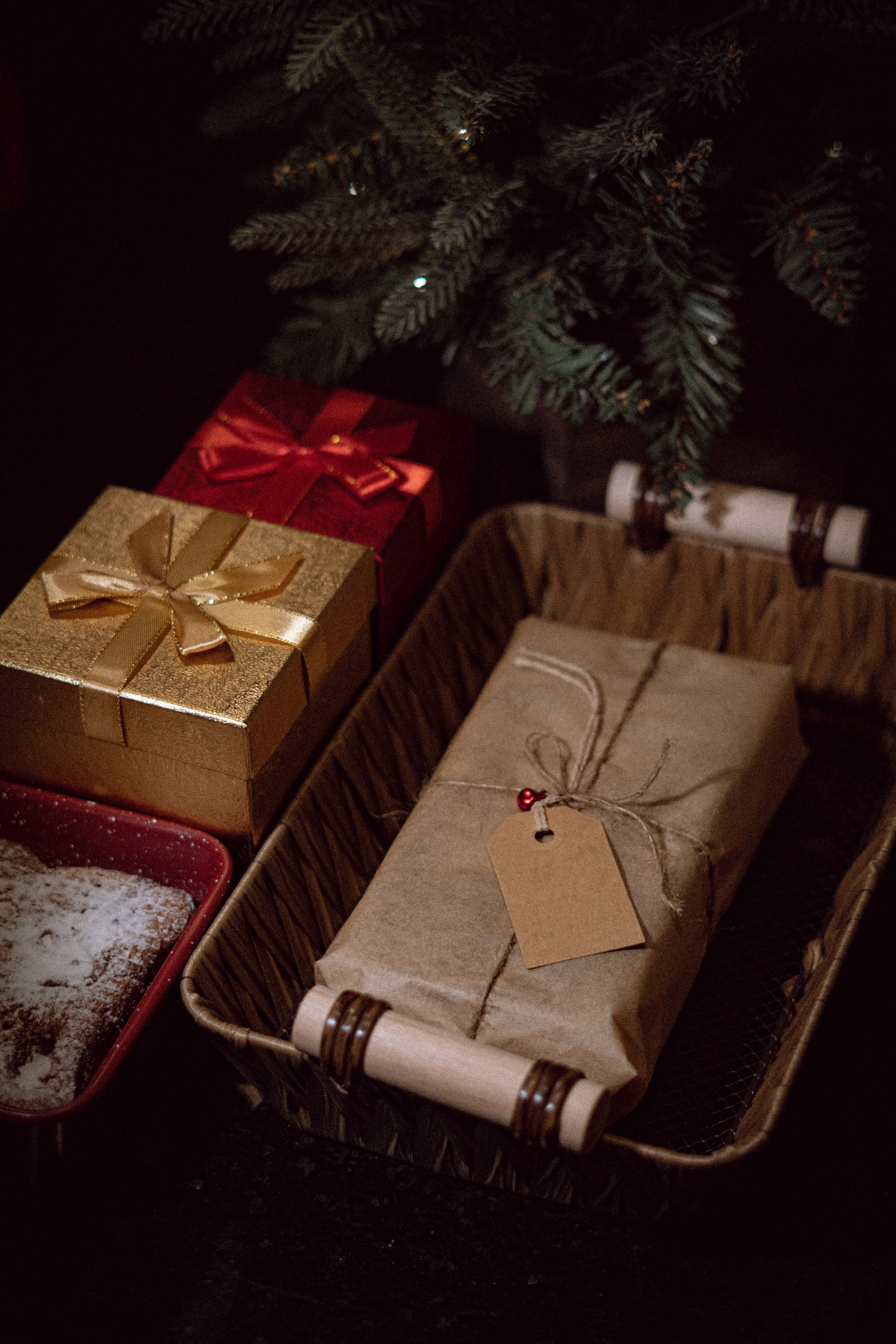 Presents wrapped in brown paper under a Christmas tree