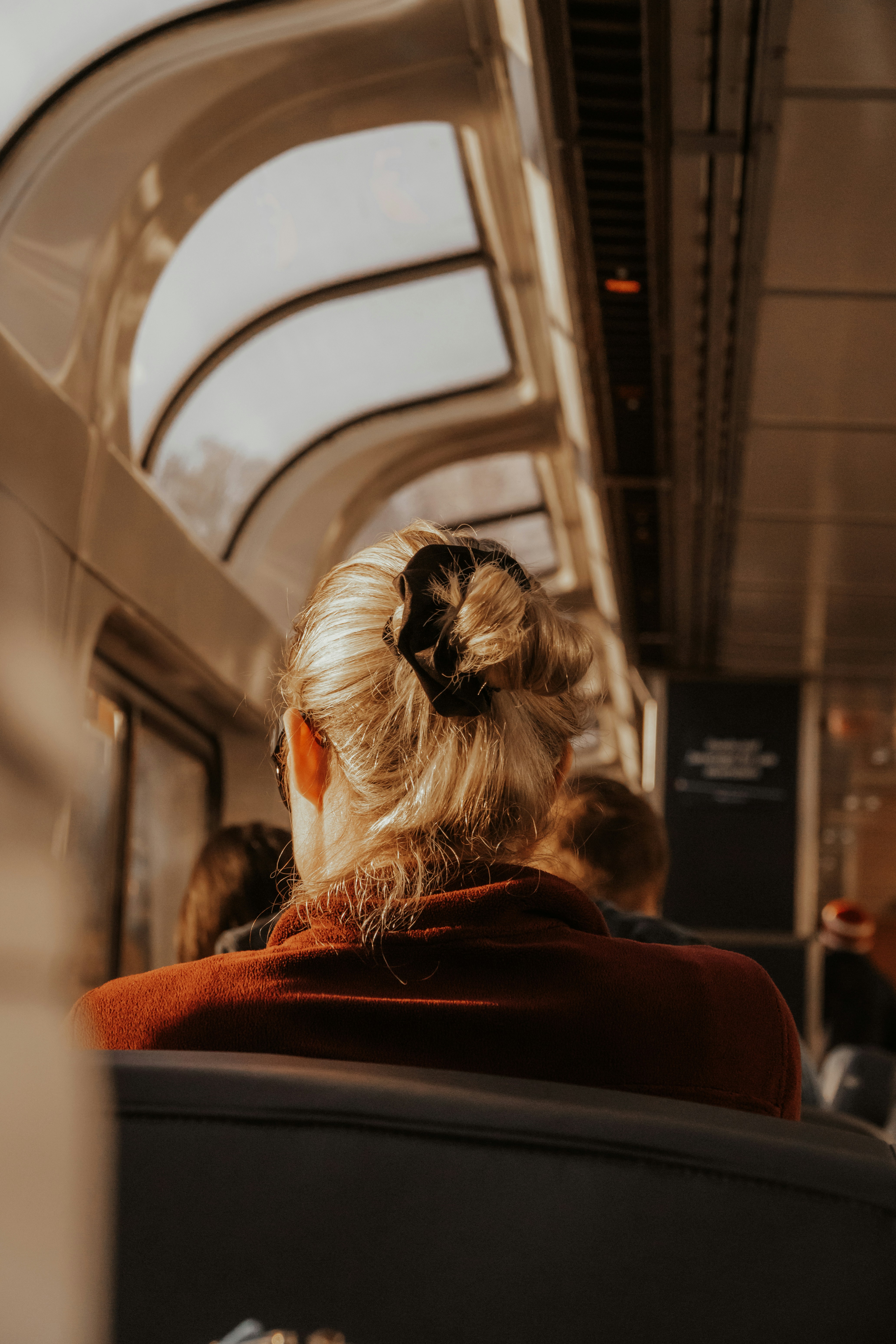 A woman sitting on a train looking out the window