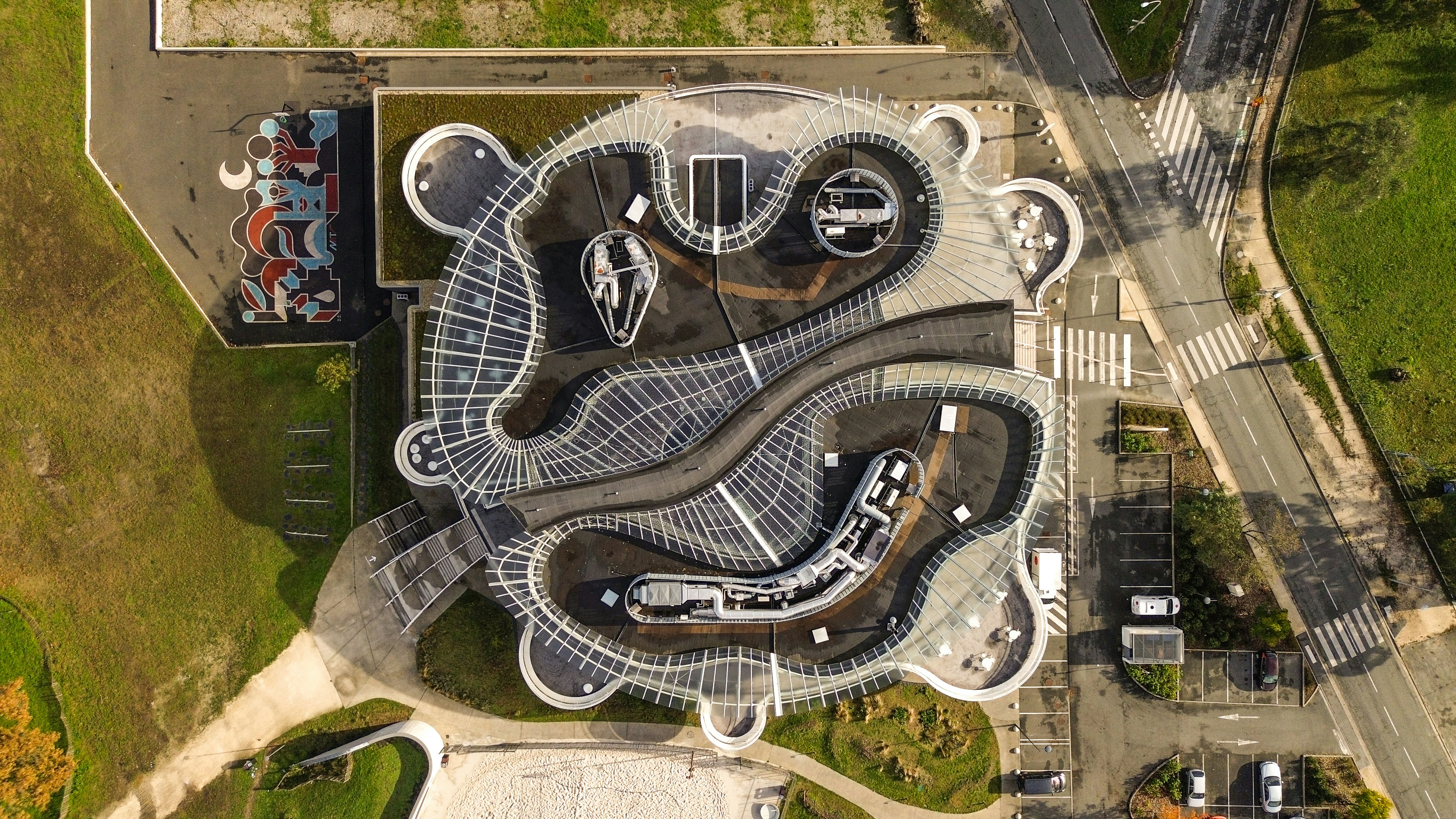 An aerial view of a parking lot with cars parked in it