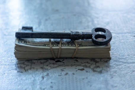 A pair of scissors sitting on top of a pile of money