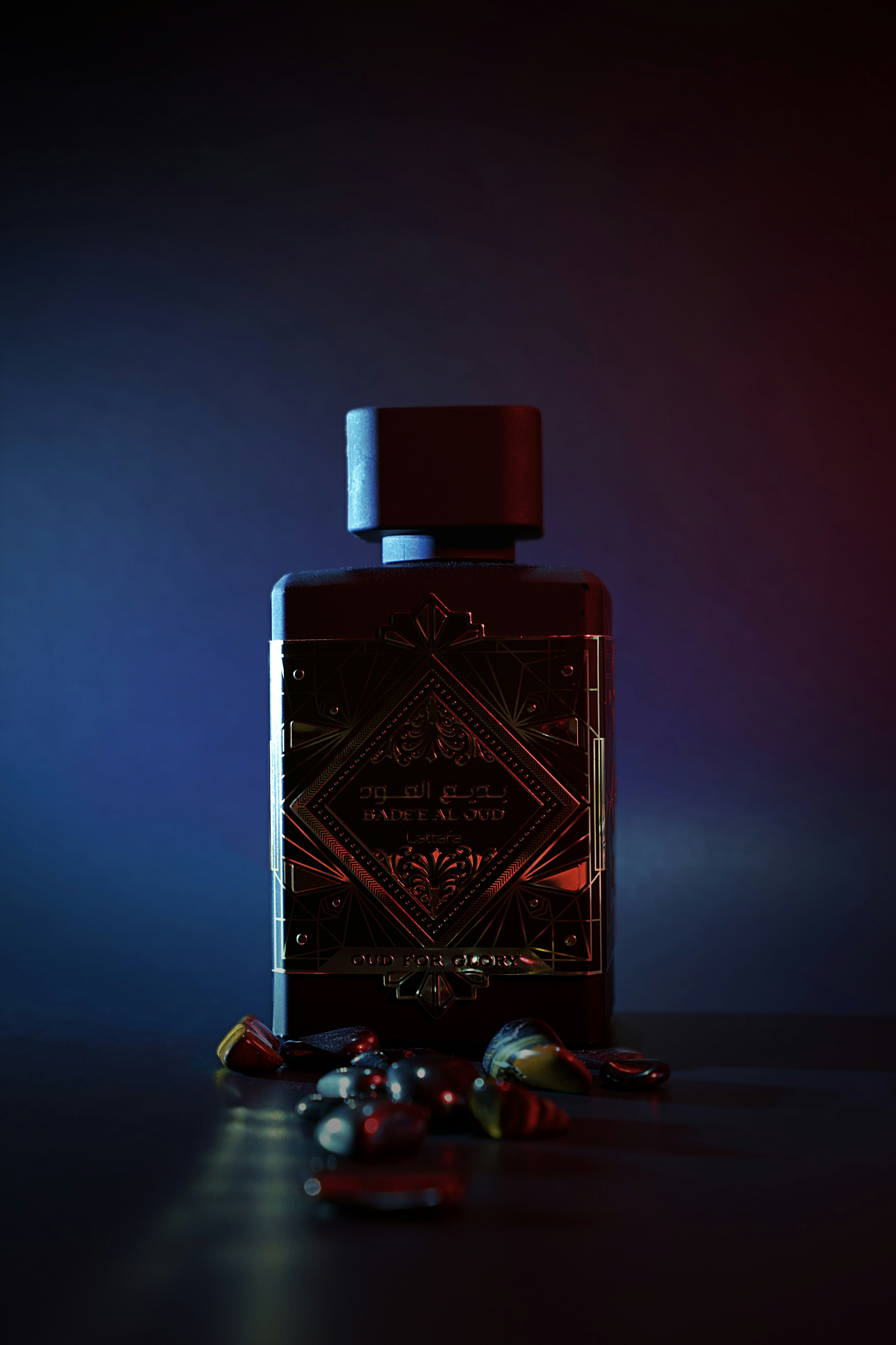 Luxury crystal perfume flacon on dark velvet, low-key dramatic lighting, black background, intense shadows