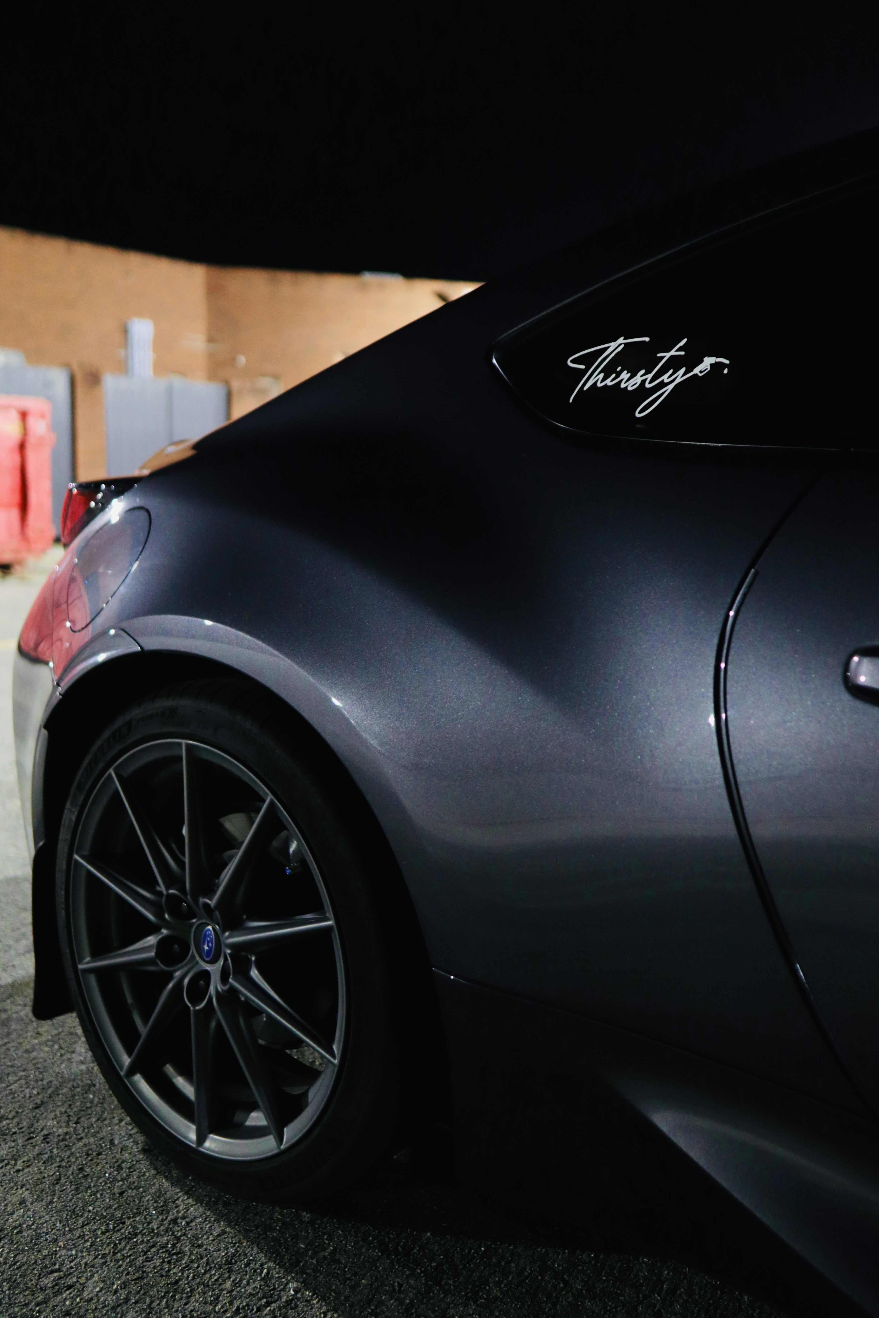 A black sports car parked in a parking lot
