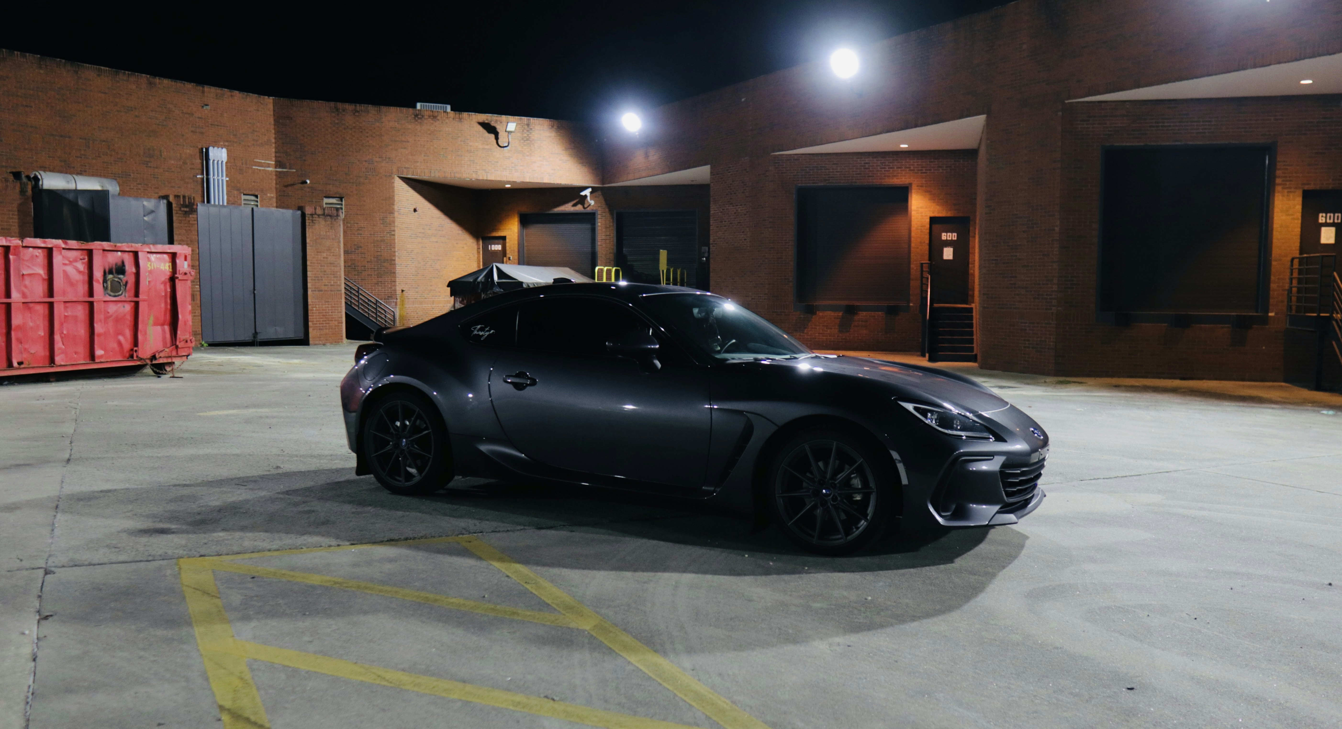 A black sports car parked in a parking lot
