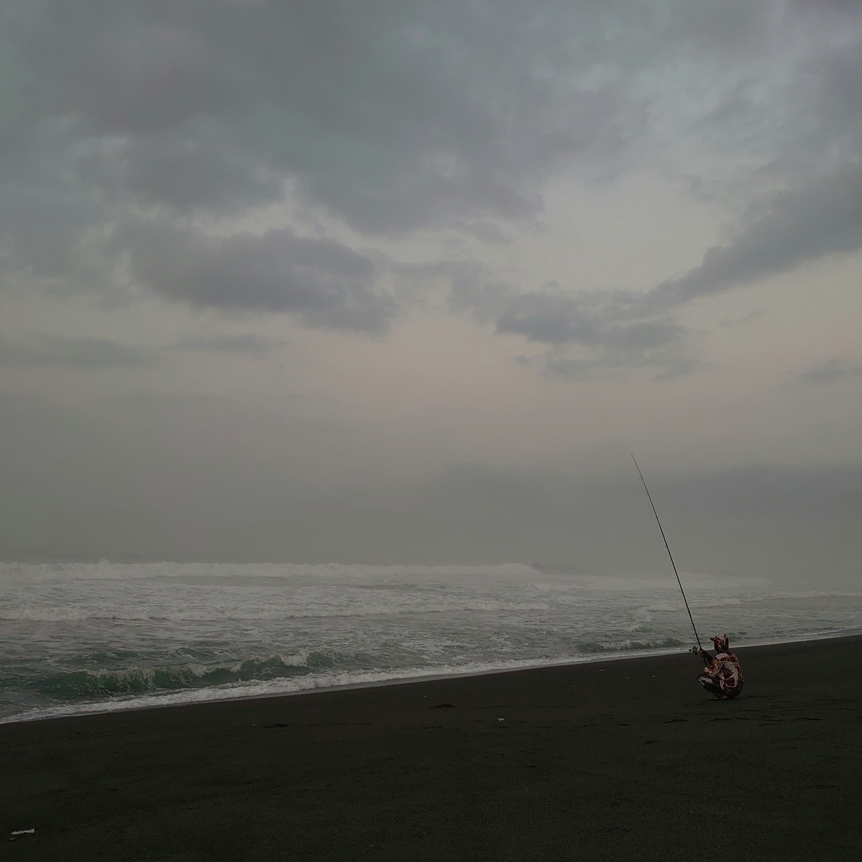 A person on a beach flying a kite