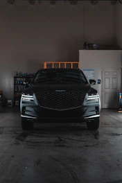 A car parked inside of a garage next to another car