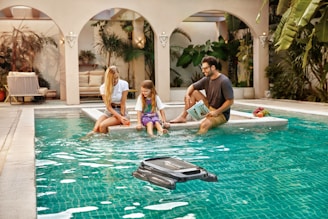 A group of people sitting around a swimming pool