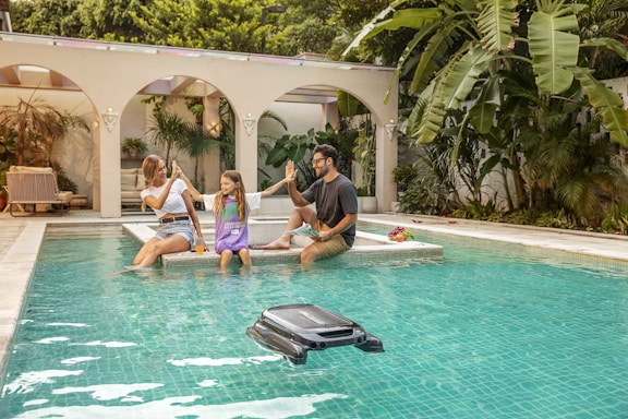 A group of people sitting around a swimming pool