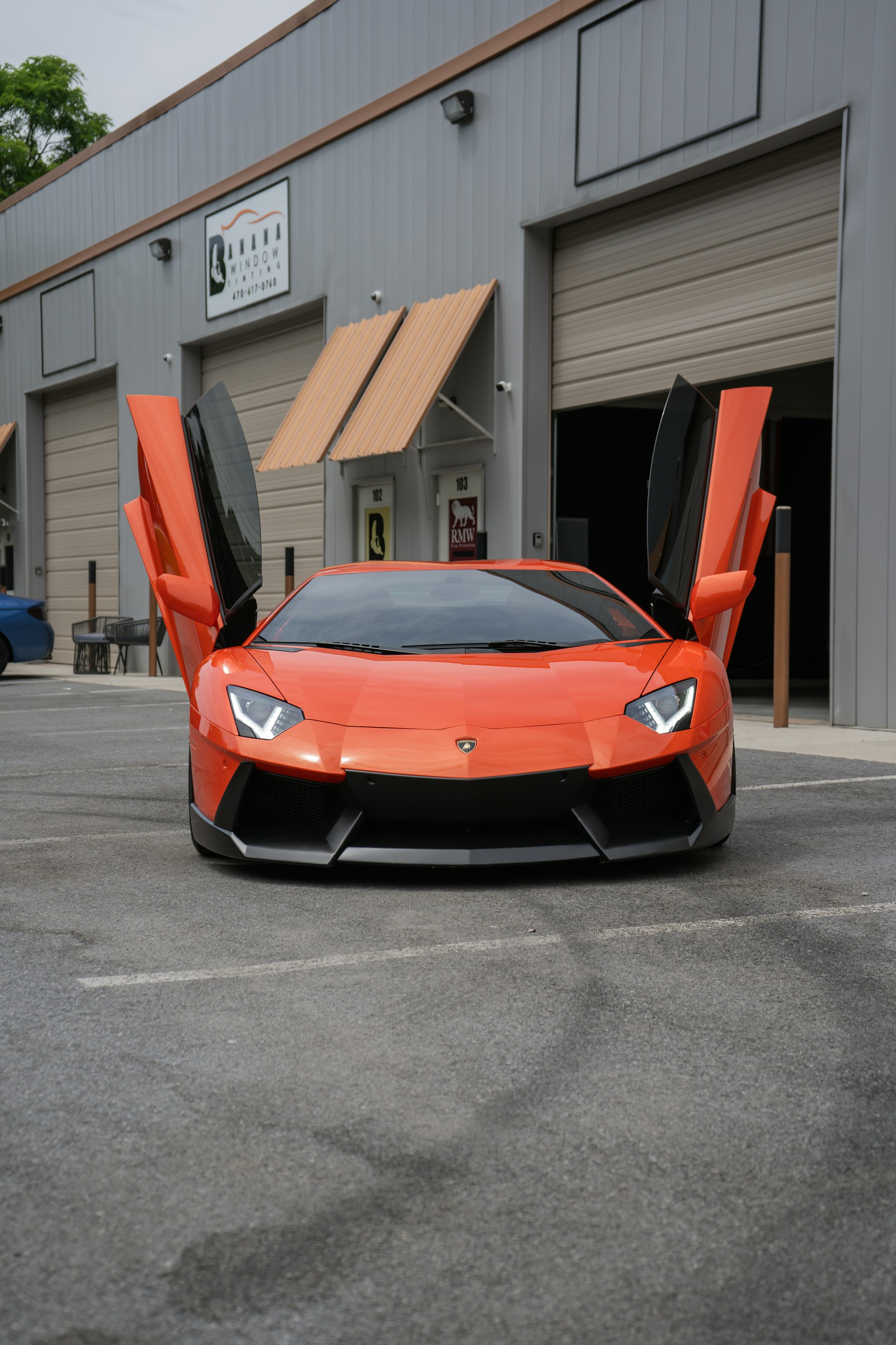 An orange sports car parked in a parking lot