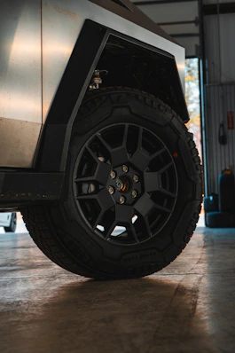 A black jeep parked inside of a garage