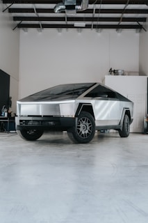 A futuristic car is parked in a garage