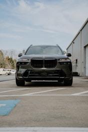 A black BMW suv parked in a parking lot
