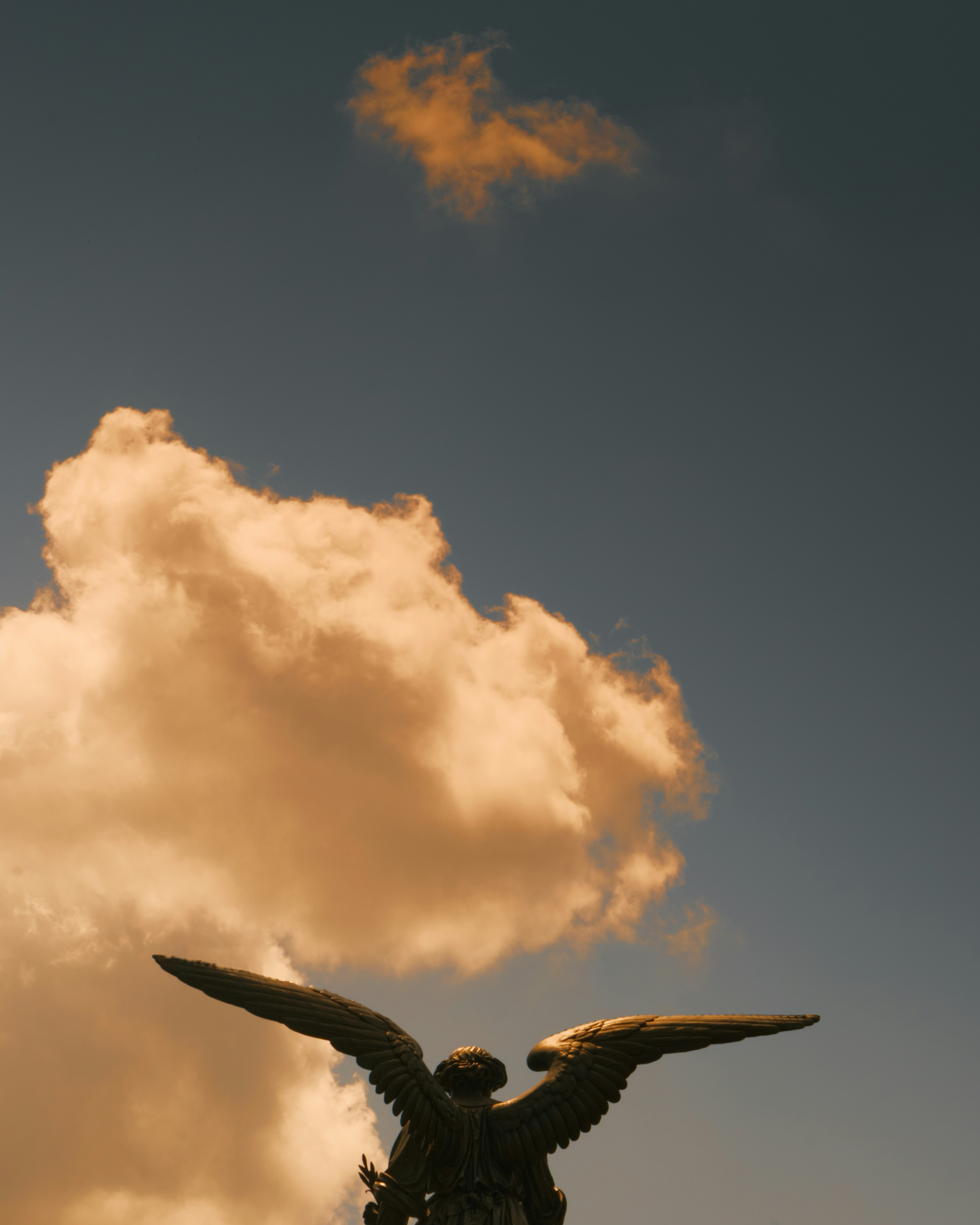 A statue of an angel on top of a building