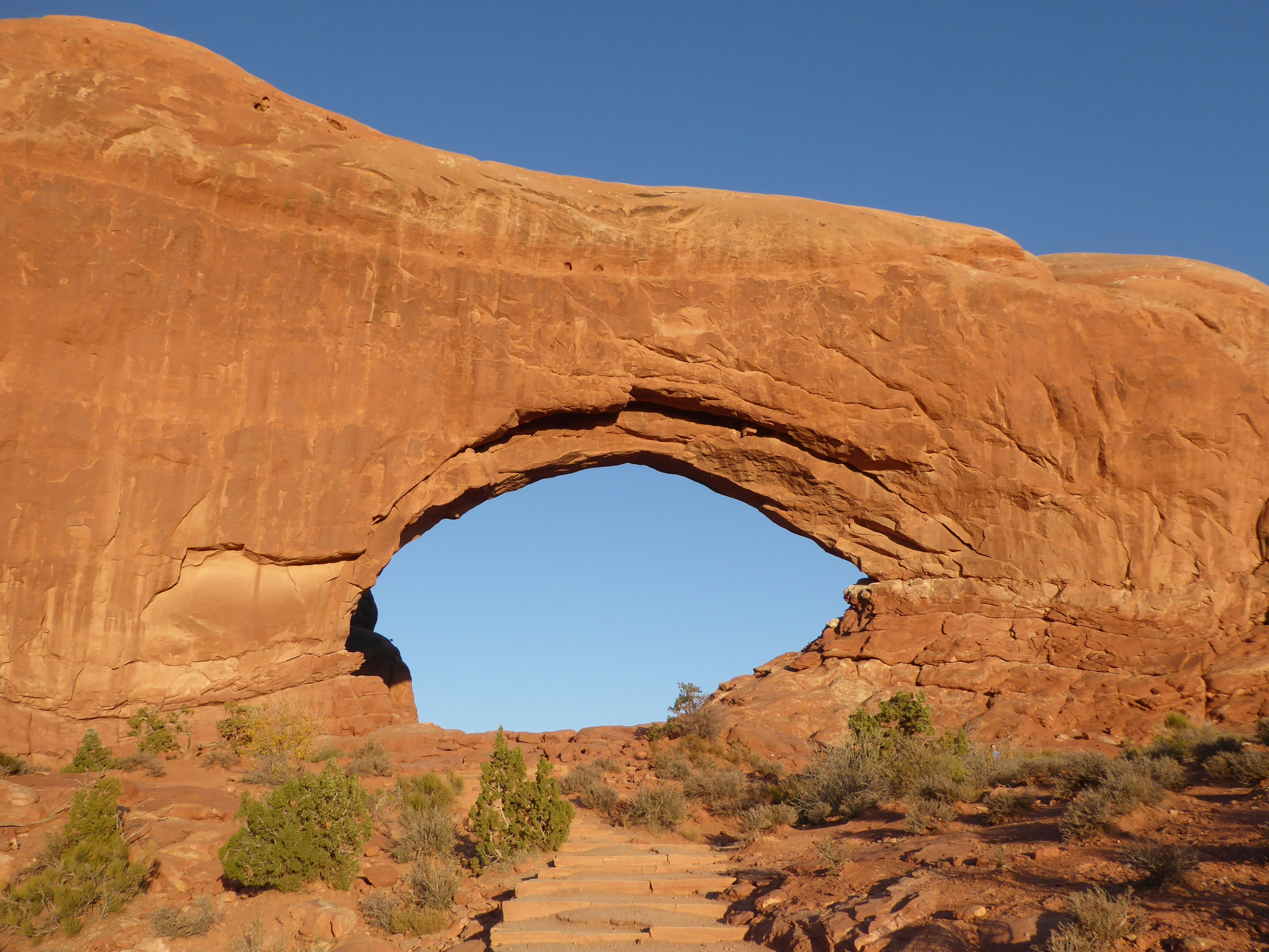 A large rock formation with a hole in the middle photo – Free Stairs ...