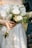 A close up of a person holding a bouquet of flowers
