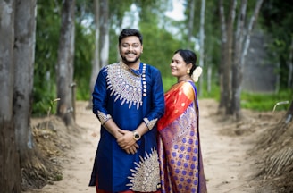 A man and a woman standing on a dirt road