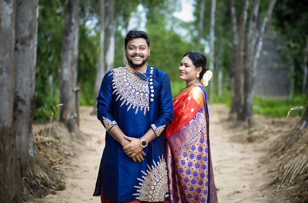 A man and a woman standing on a dirt road